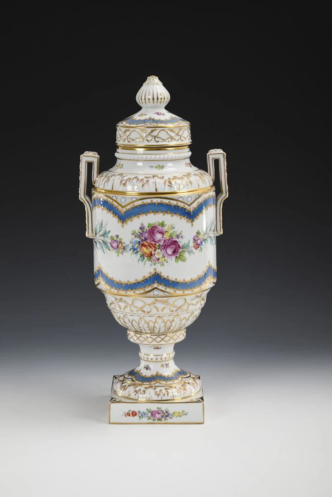 Lidded vase with floral design.