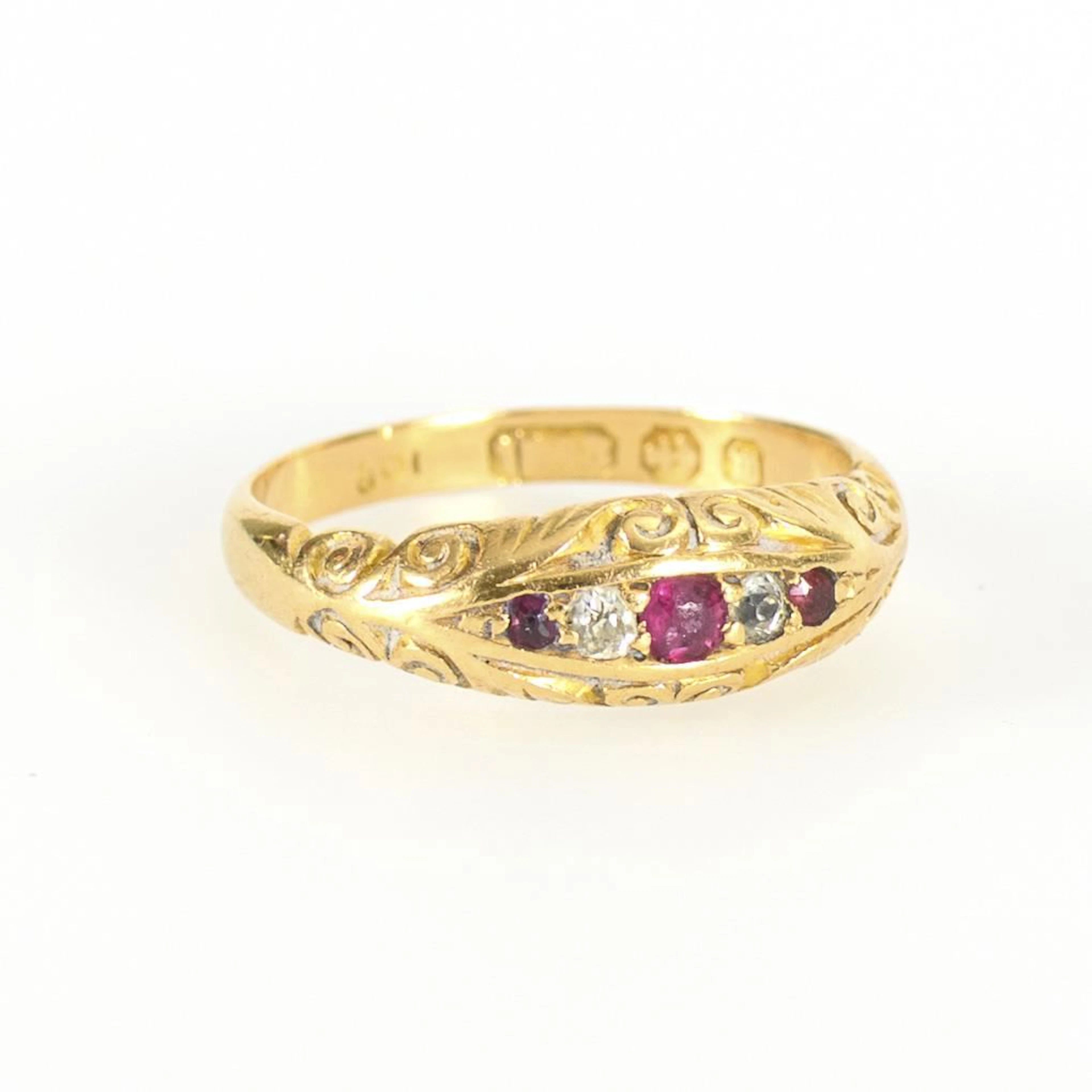Antique ring with small diamonds and red gemstones.