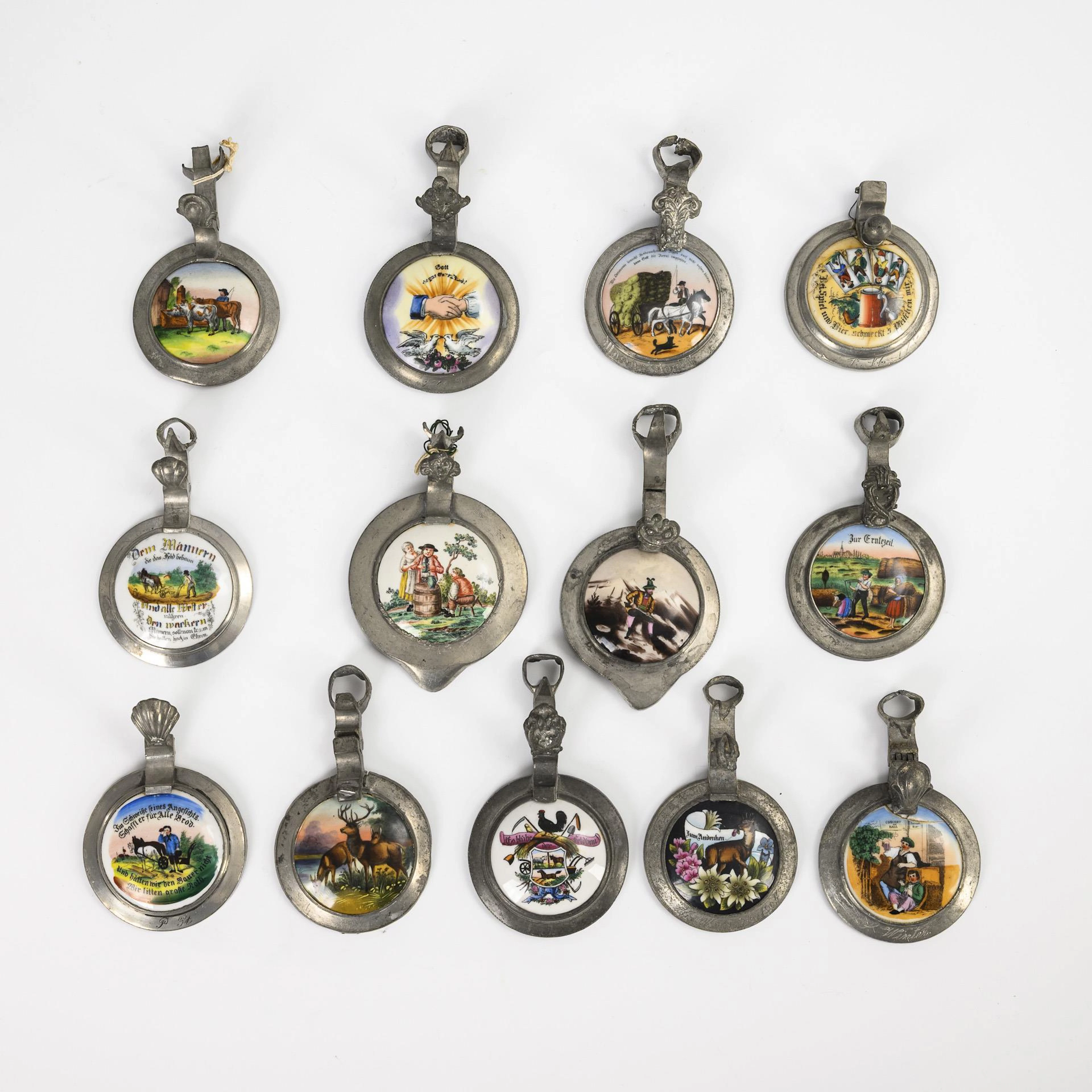 13 beer mug lids with porcelain plaques.
