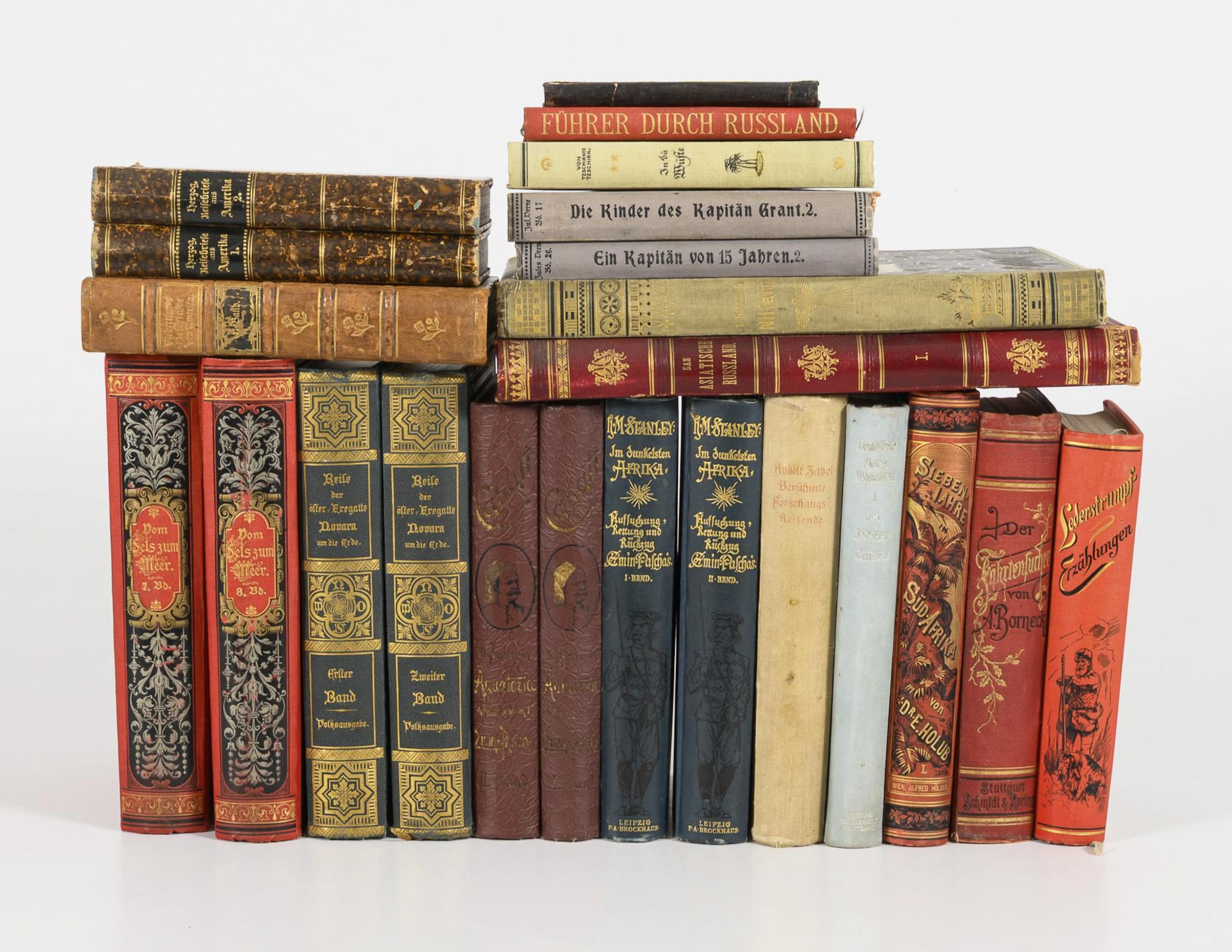 Small library of travel and adventure literature, mostly from around 1900