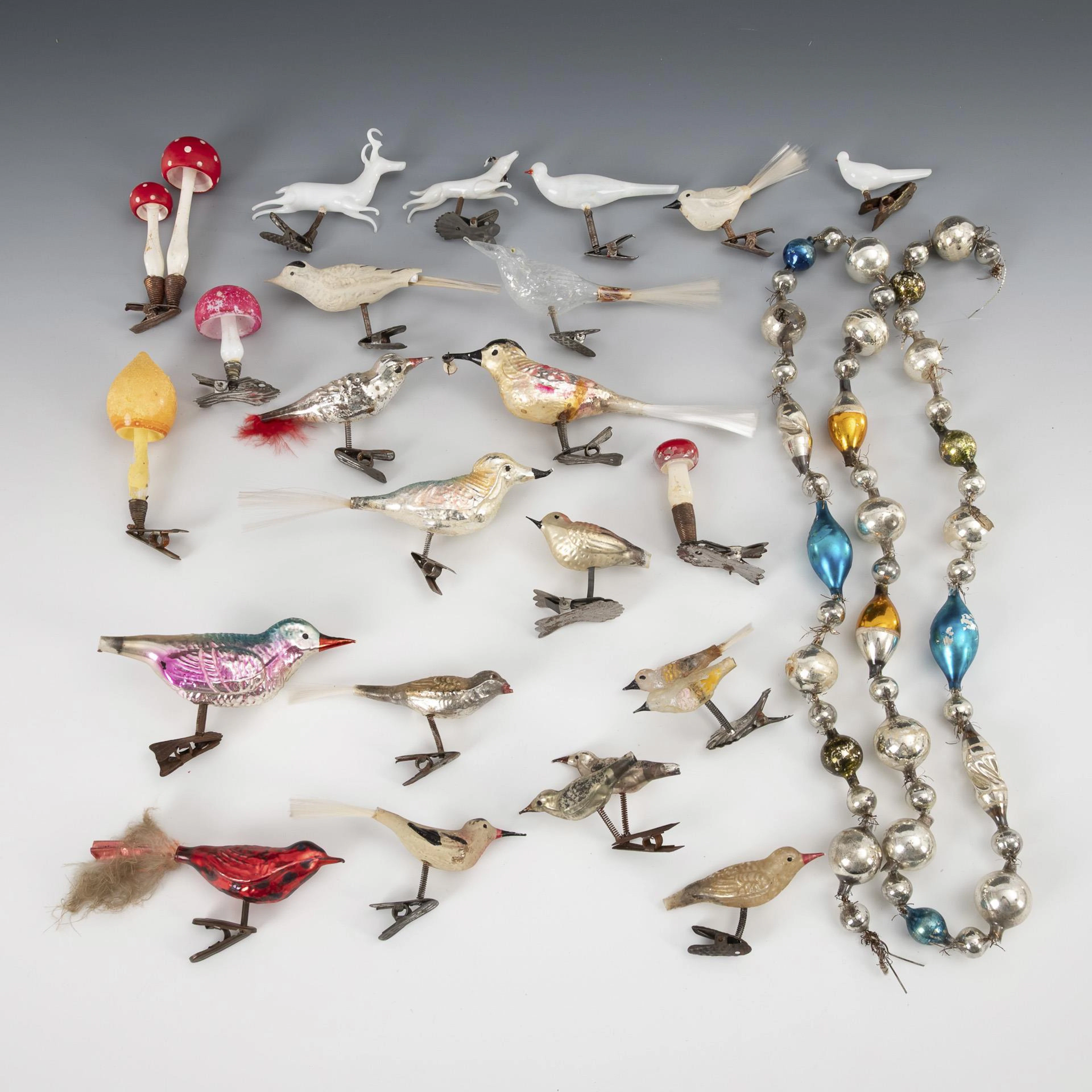 A collection of old Christmas tree decorations with clip and chain.