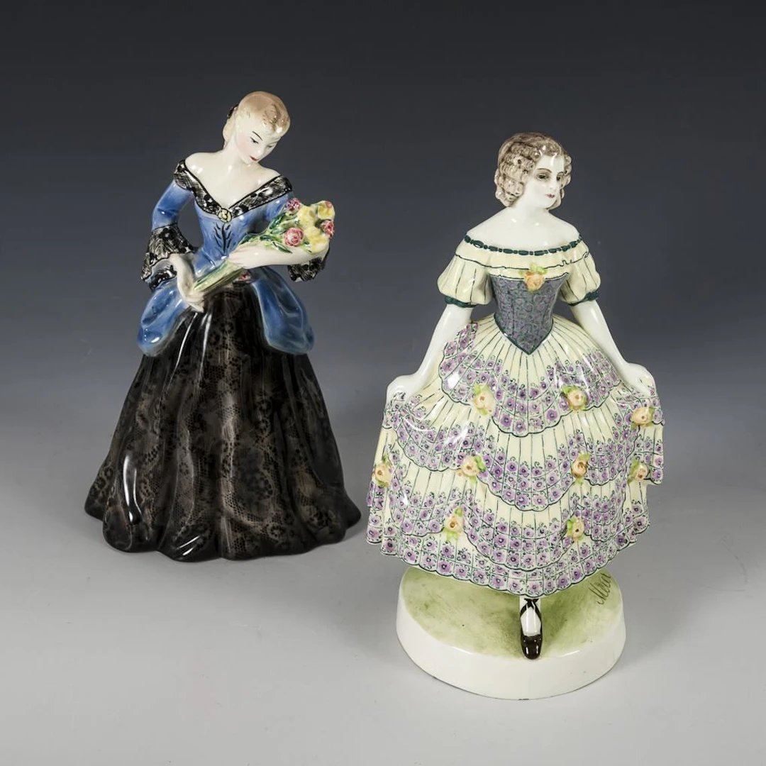2 figures: a woman in a black skirt with flowers and a woman in a floral dress.