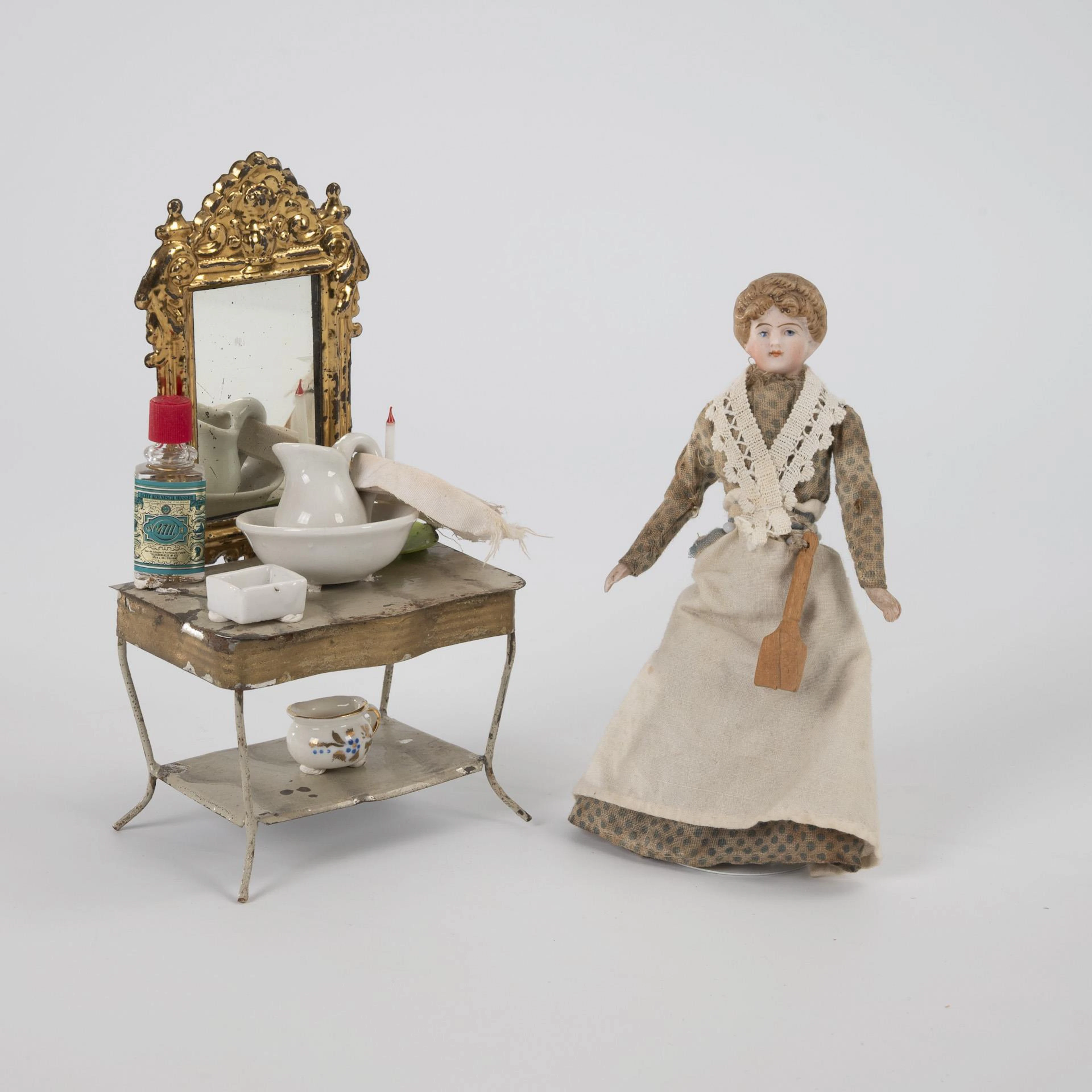 Dollhouse doll and tin washbasin with accessories.