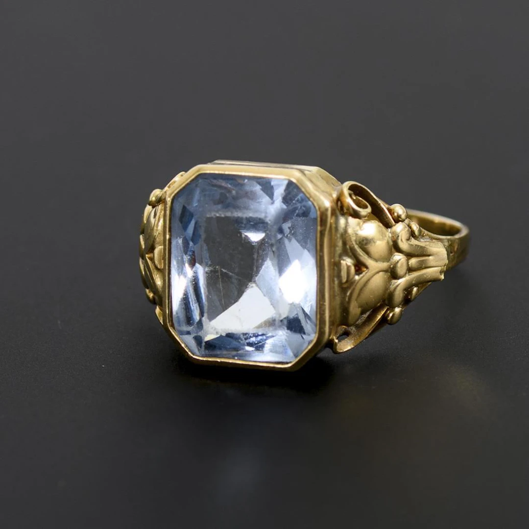 Ring with blue gemstone or synthetic stone.