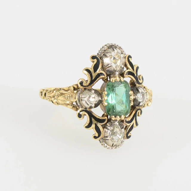 Ring with a green gemstone, likely an emerald.