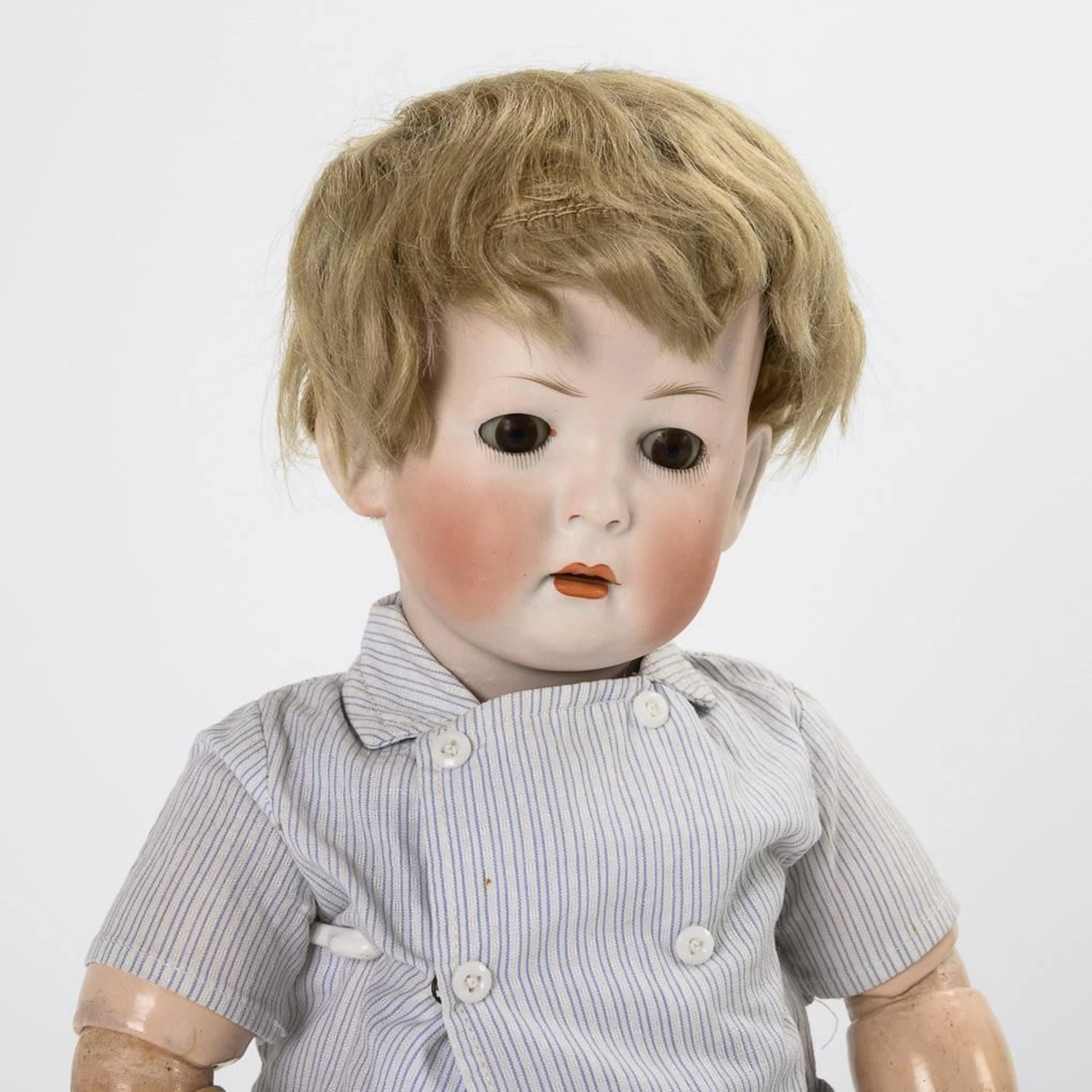 Blond boy with a character face wearing corduroy pants. König & Wernicke.