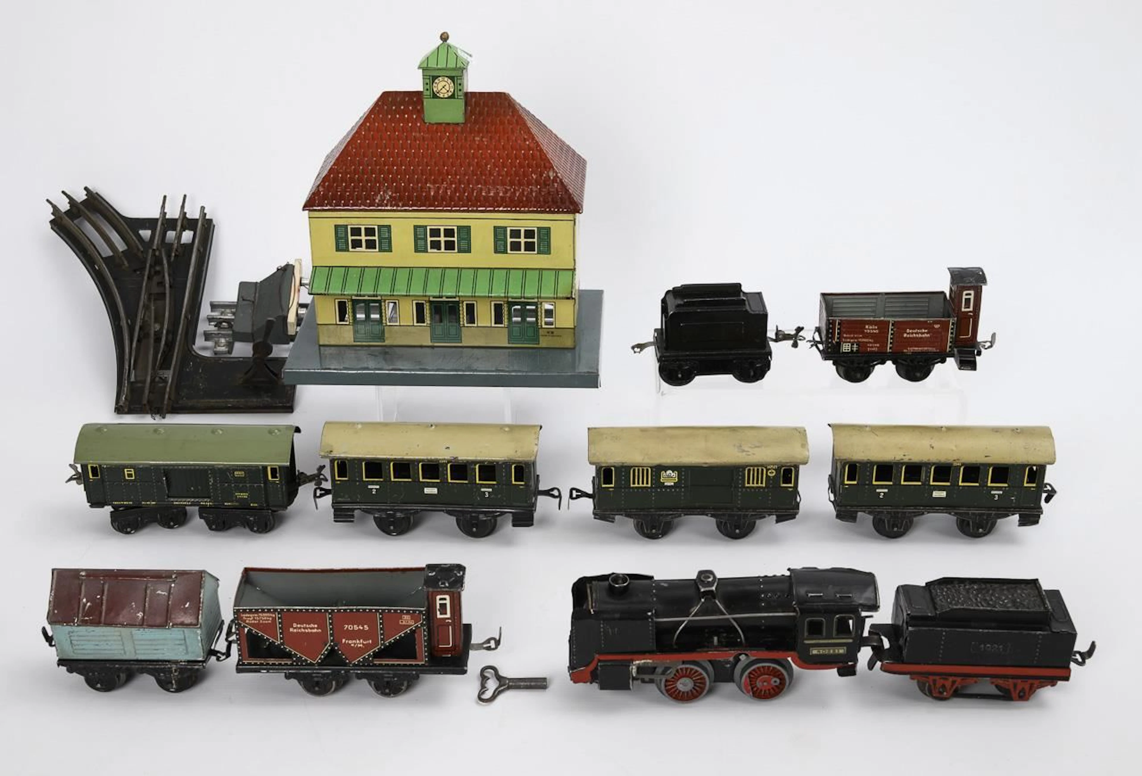 Railroad set with locomotive, station, cars, and tracks. Johann Distler