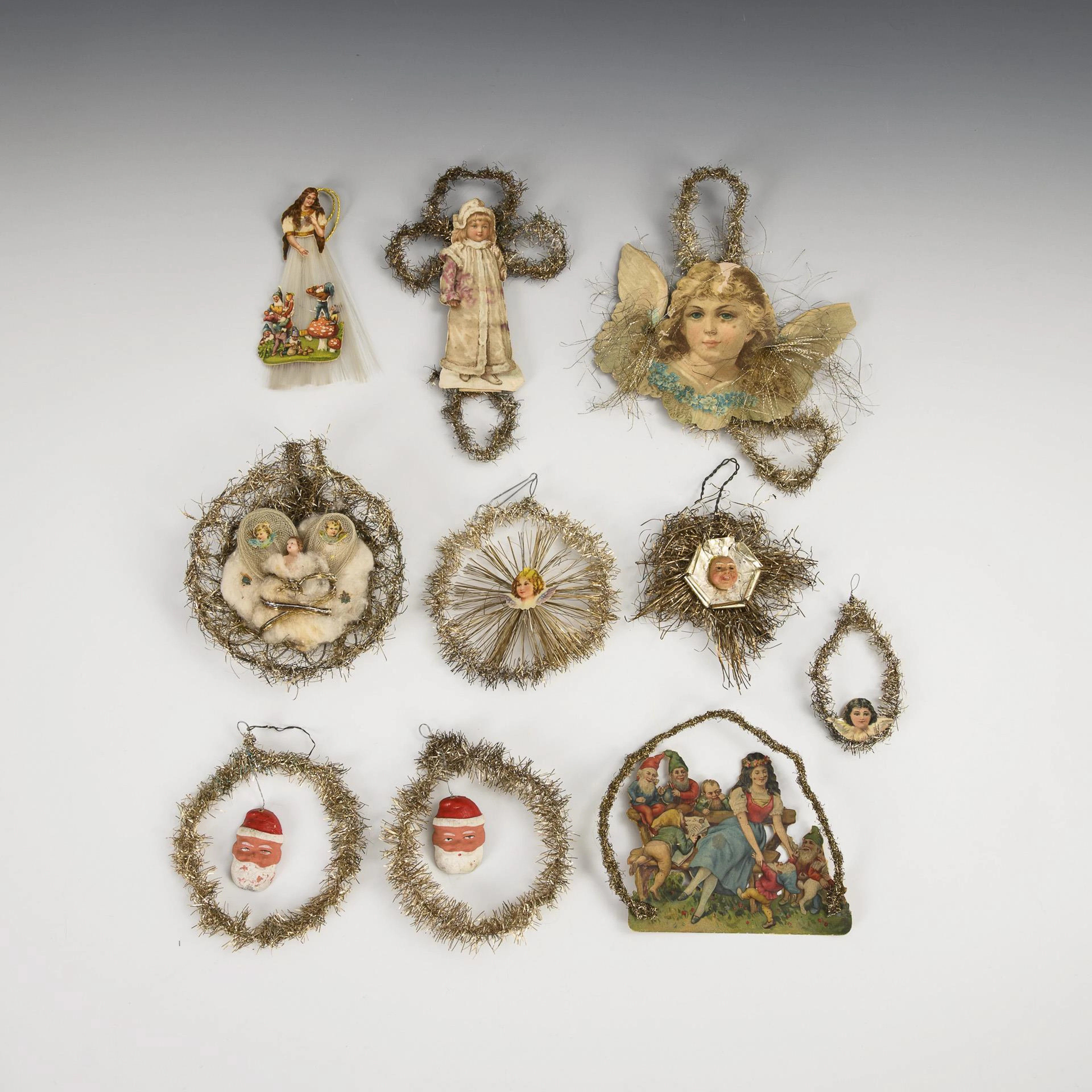 A collection of old Christmas tree decorations with wafers and tinsel.