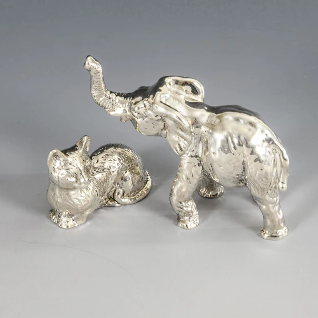 2 miniature silver animal figurines.