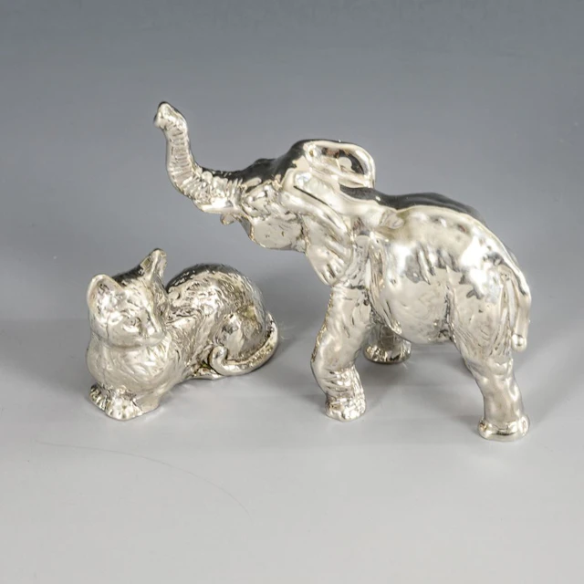 2 miniature silver animal figurines.