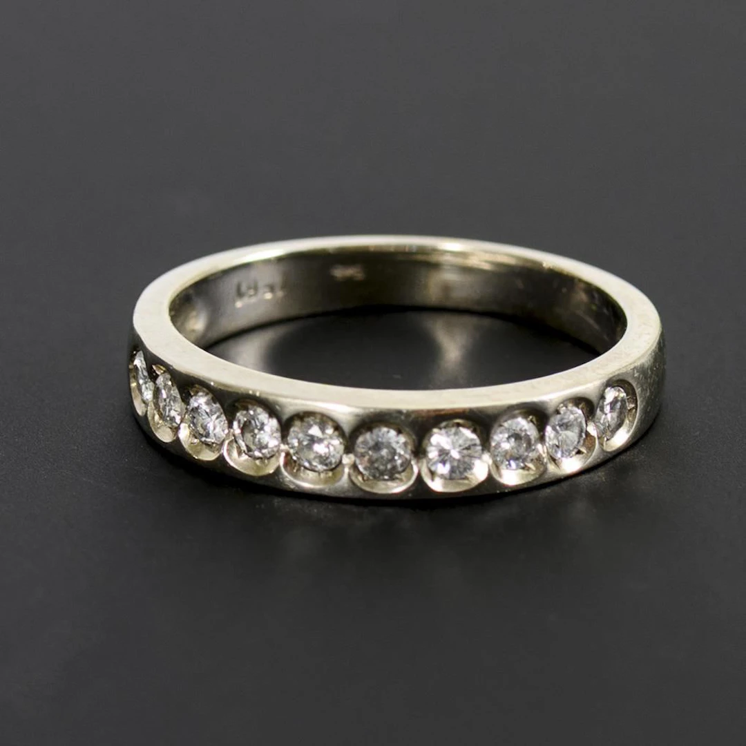 Band ring with diamond setting.