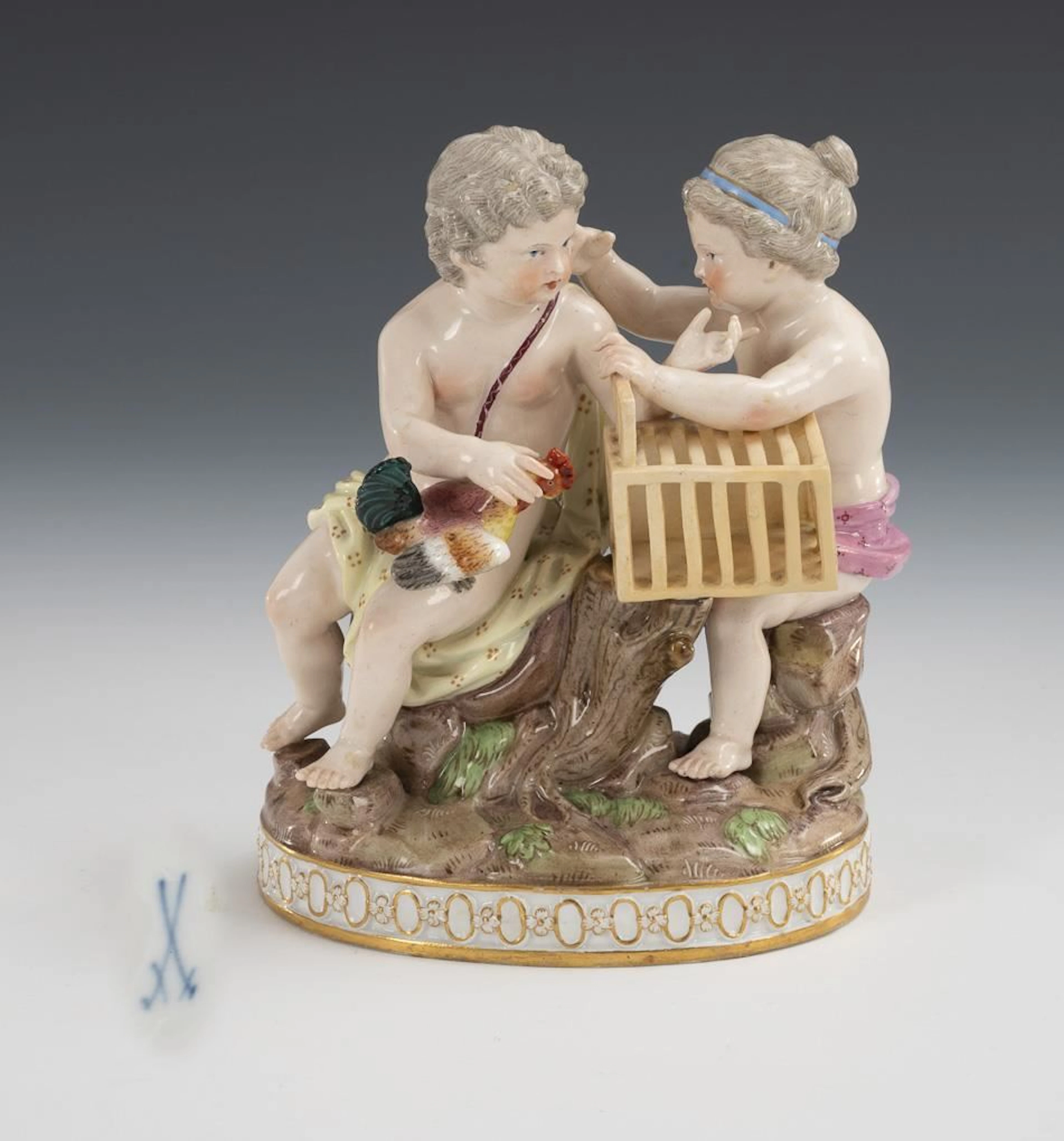 Group of cherubs with a rooster and a cage. Meissen.