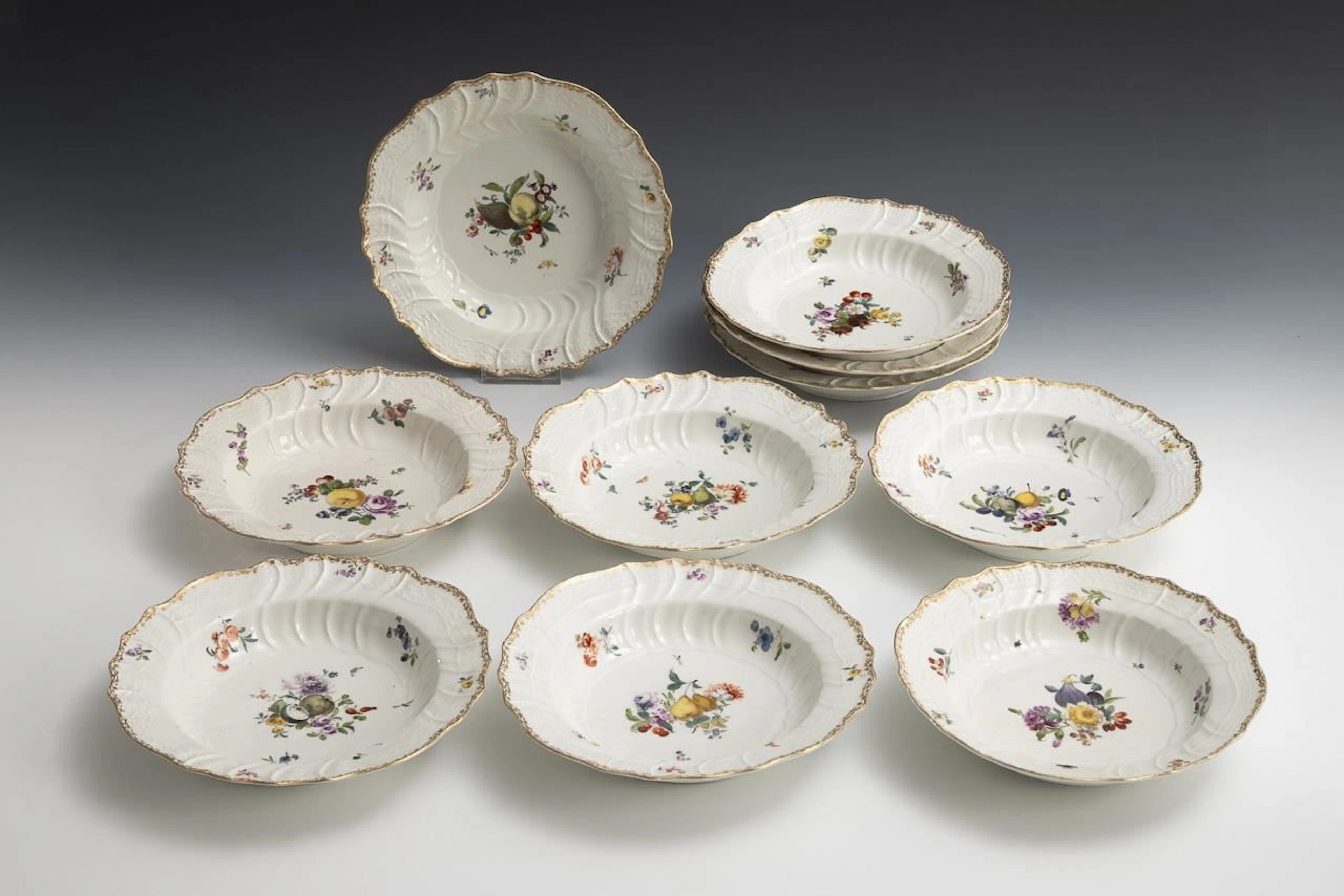 10 Baroque soup plates with fruit and flower motifs. Meissen.