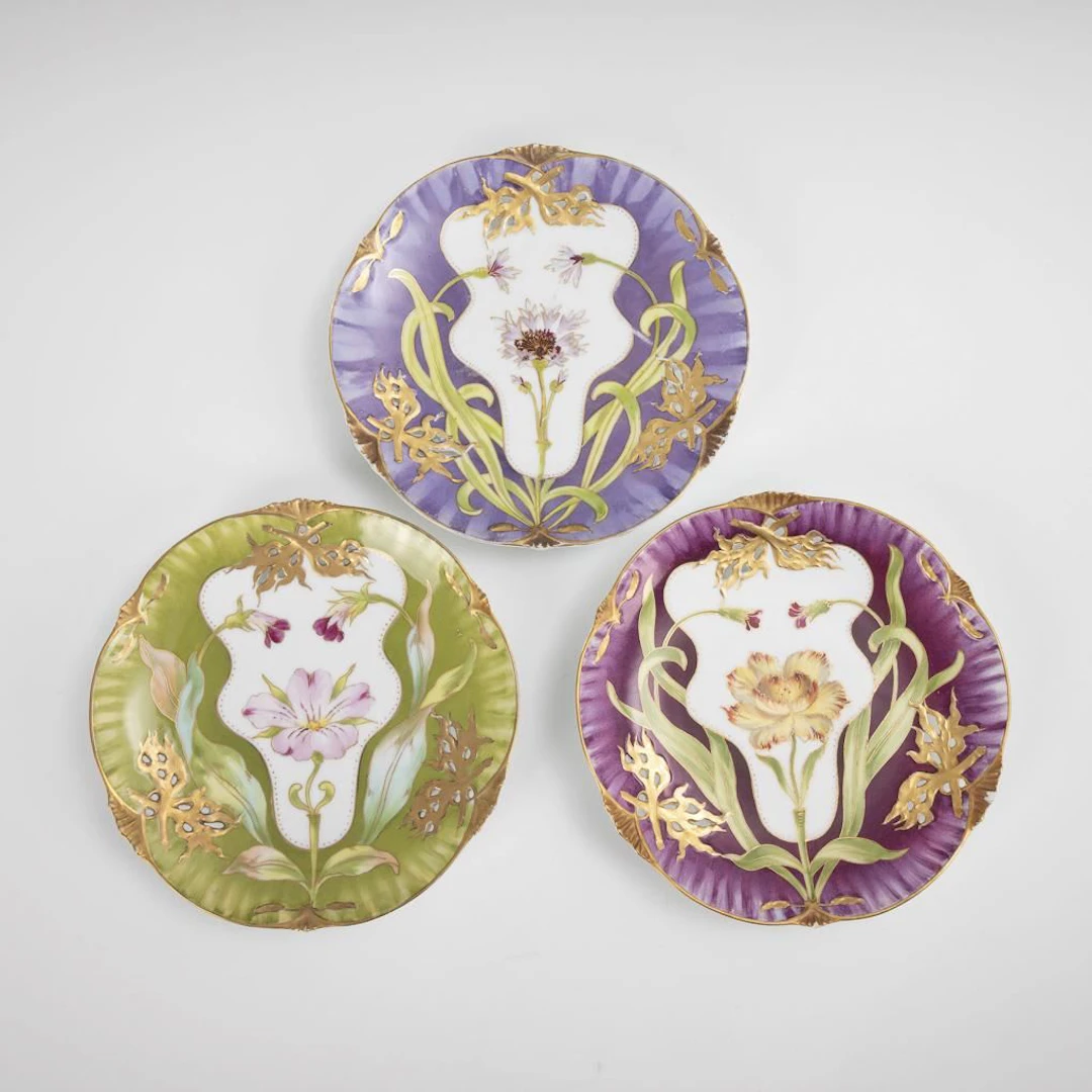 3 Art Nouveau dessert plates with floral designs. Nymphenburg.