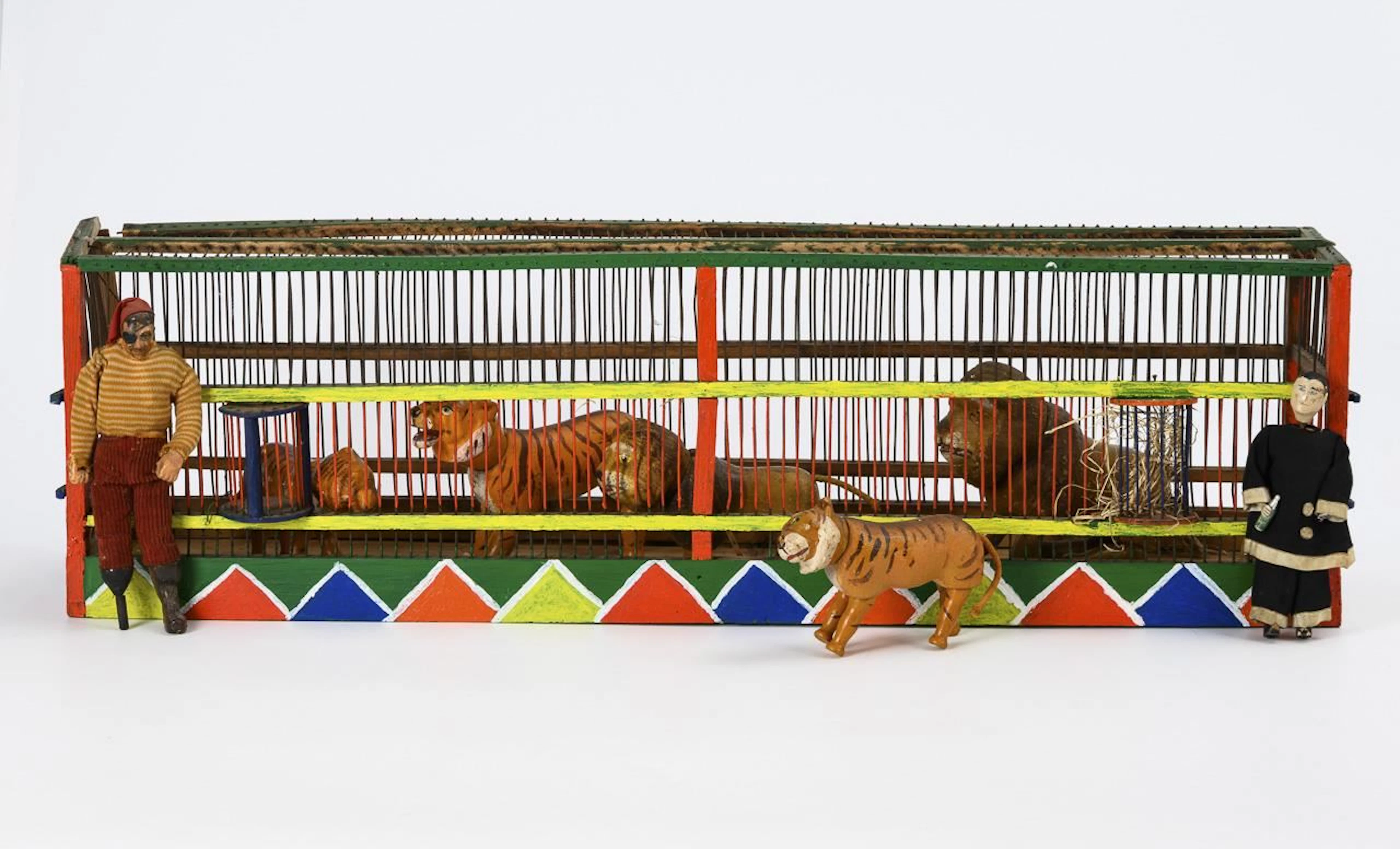 5 Humpty Dumpty animals and 2 figures in a predator cage. Albert Schoenhut.