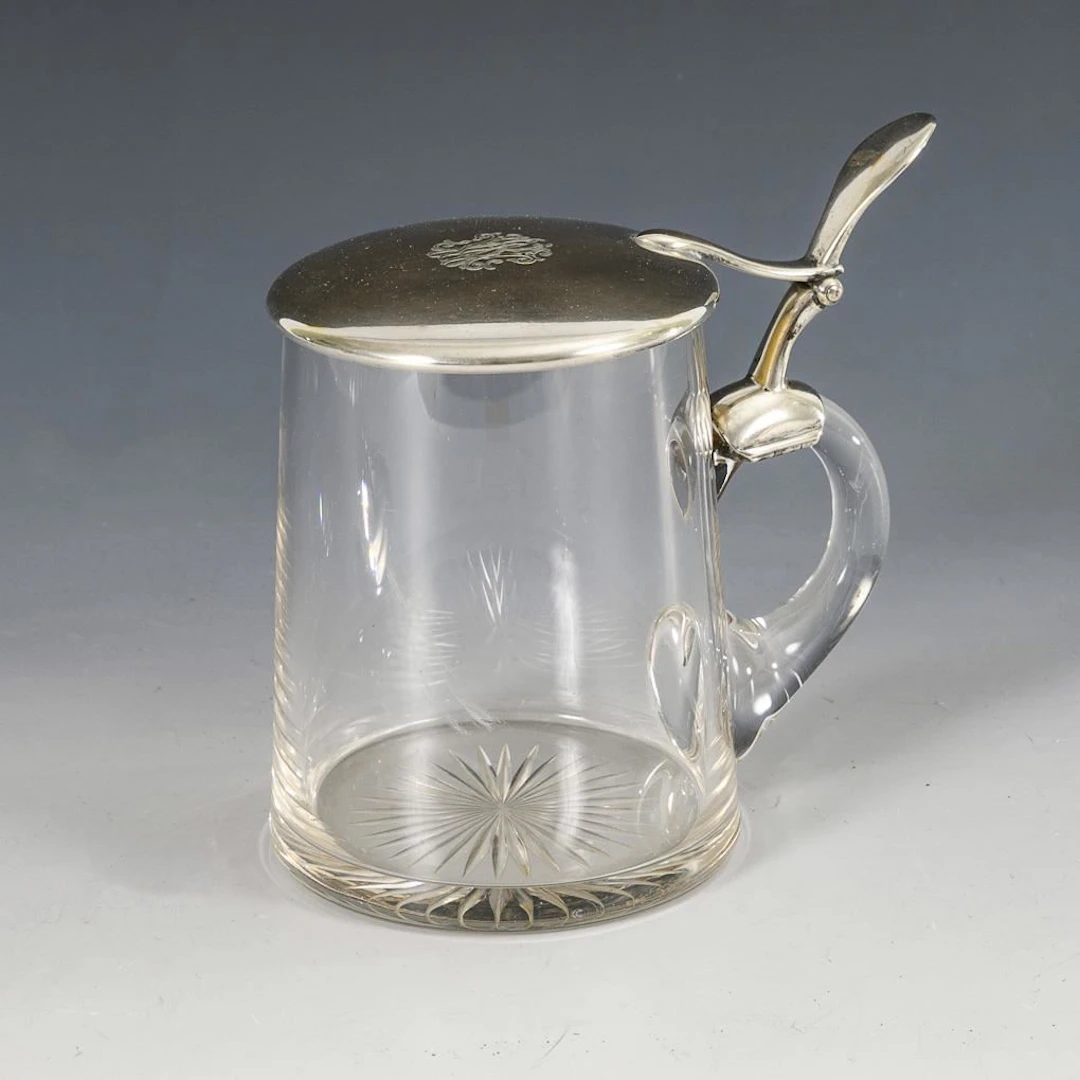 Glass jug with silver lid.