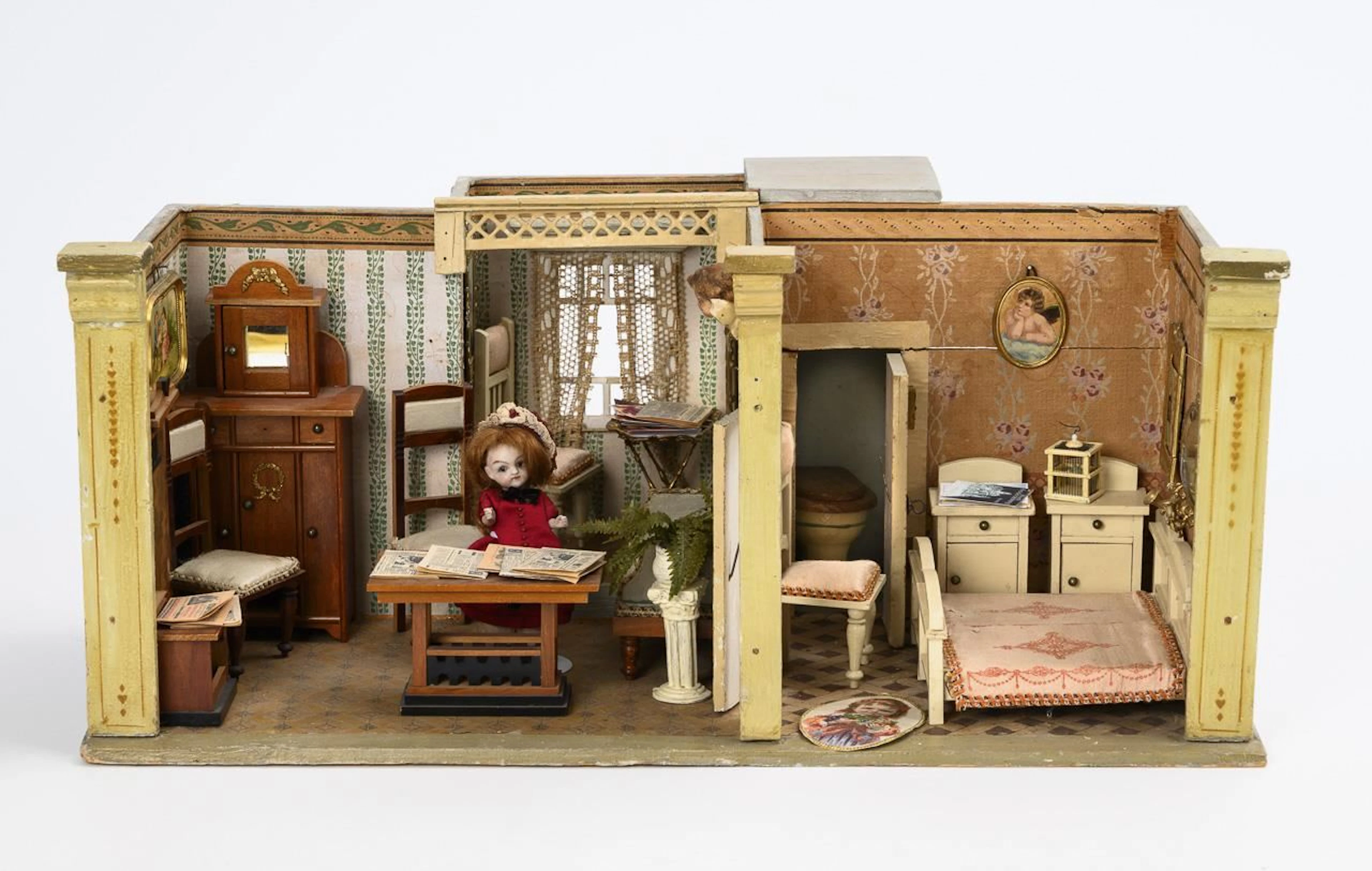 Small dollhouse with a bay window and a bathroom.