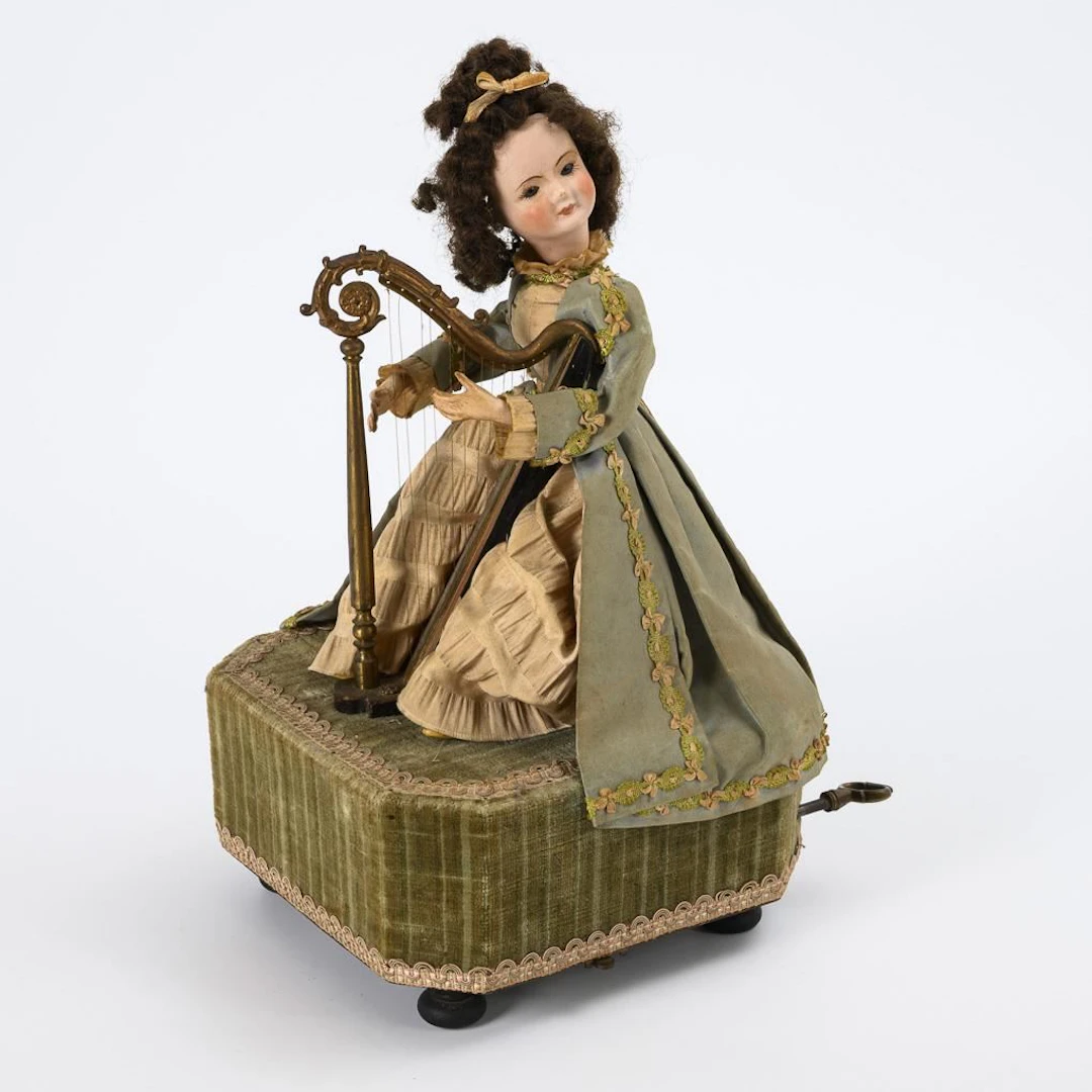 Automatic doll with a harp.
