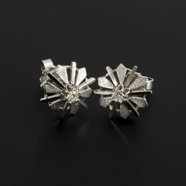 Pair of modernist stud earrings with brilliant-cut diamonds.