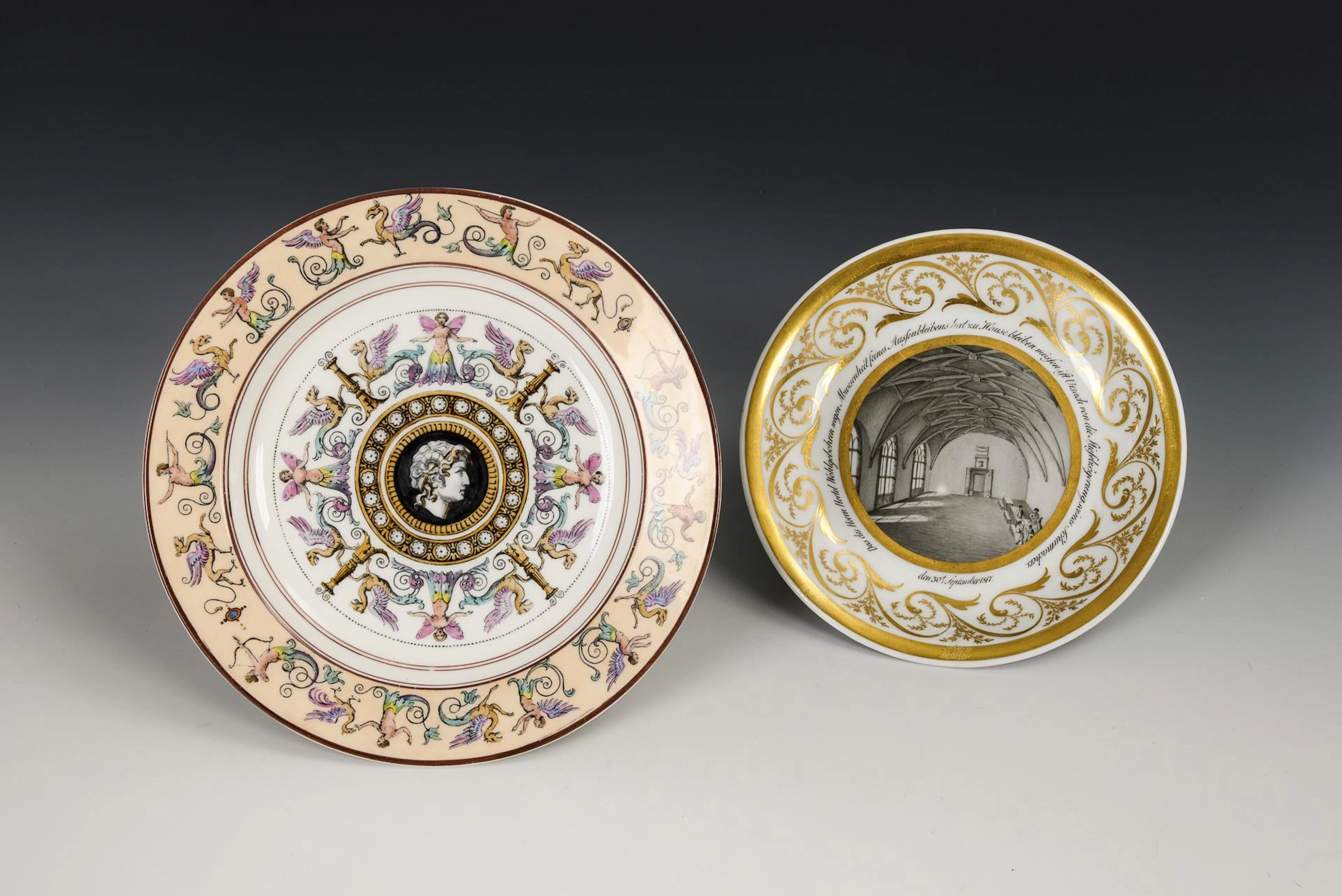Saucer with grisaille painting and plate with grotesque motif. KPM Berlin.