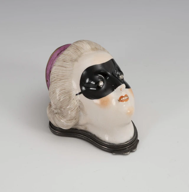 Can in the shape of a woman's head.