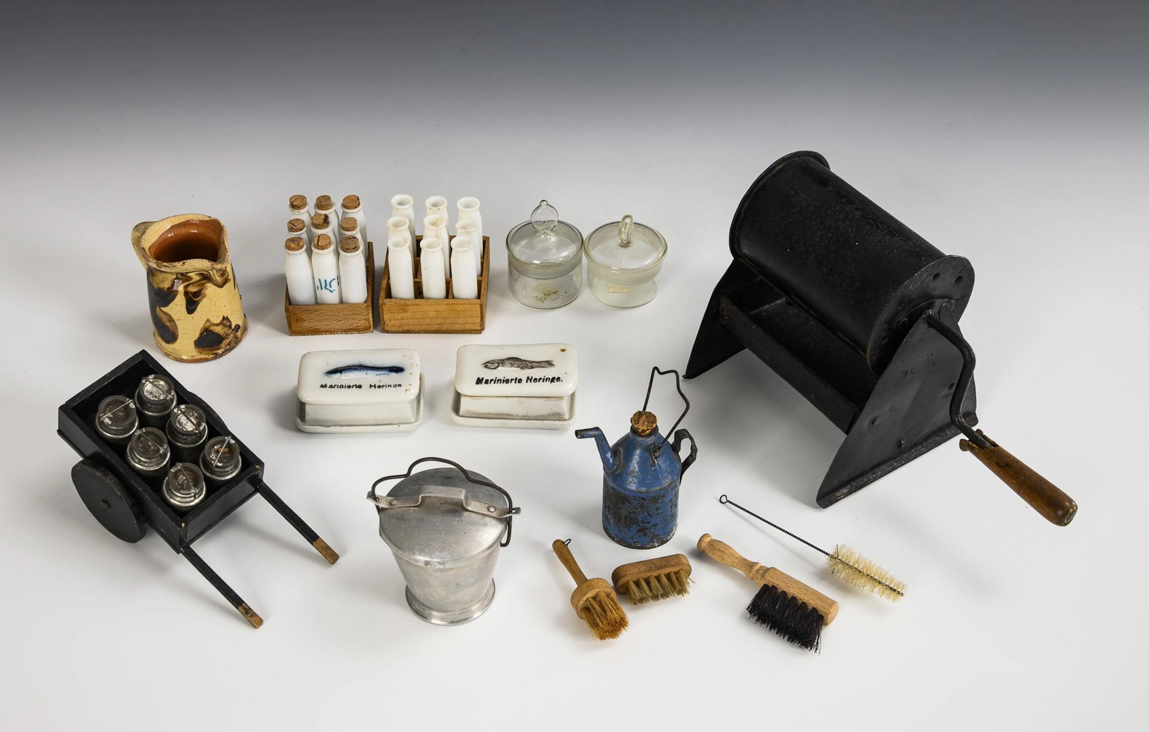 A collection of doll's kitchen accessories with coffee roaster.