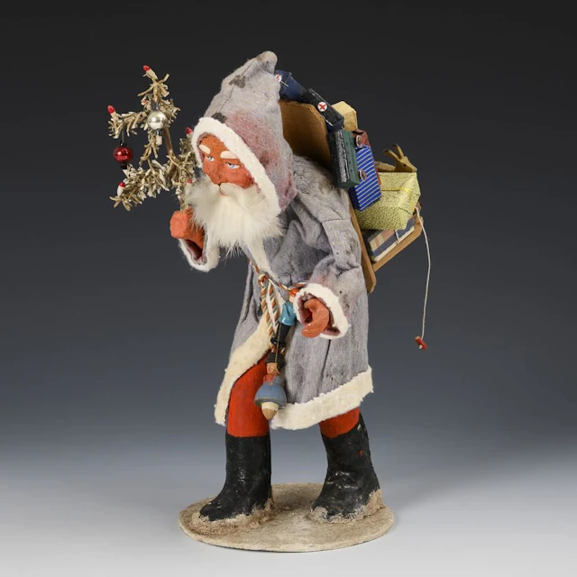Santa Claus in a blue coat.
