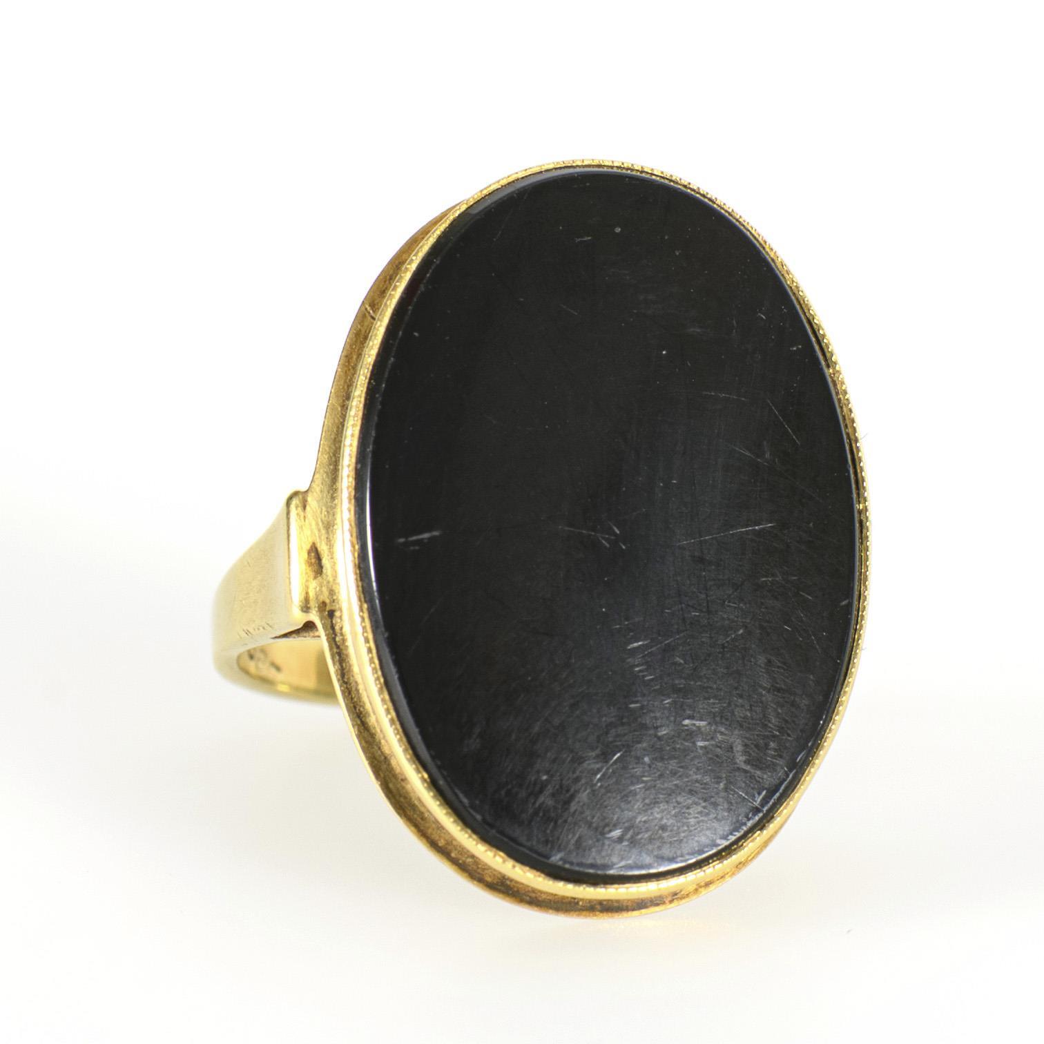 Ring with oval onyx plaque.