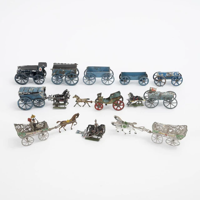 Assortment of metal cars and carriages.