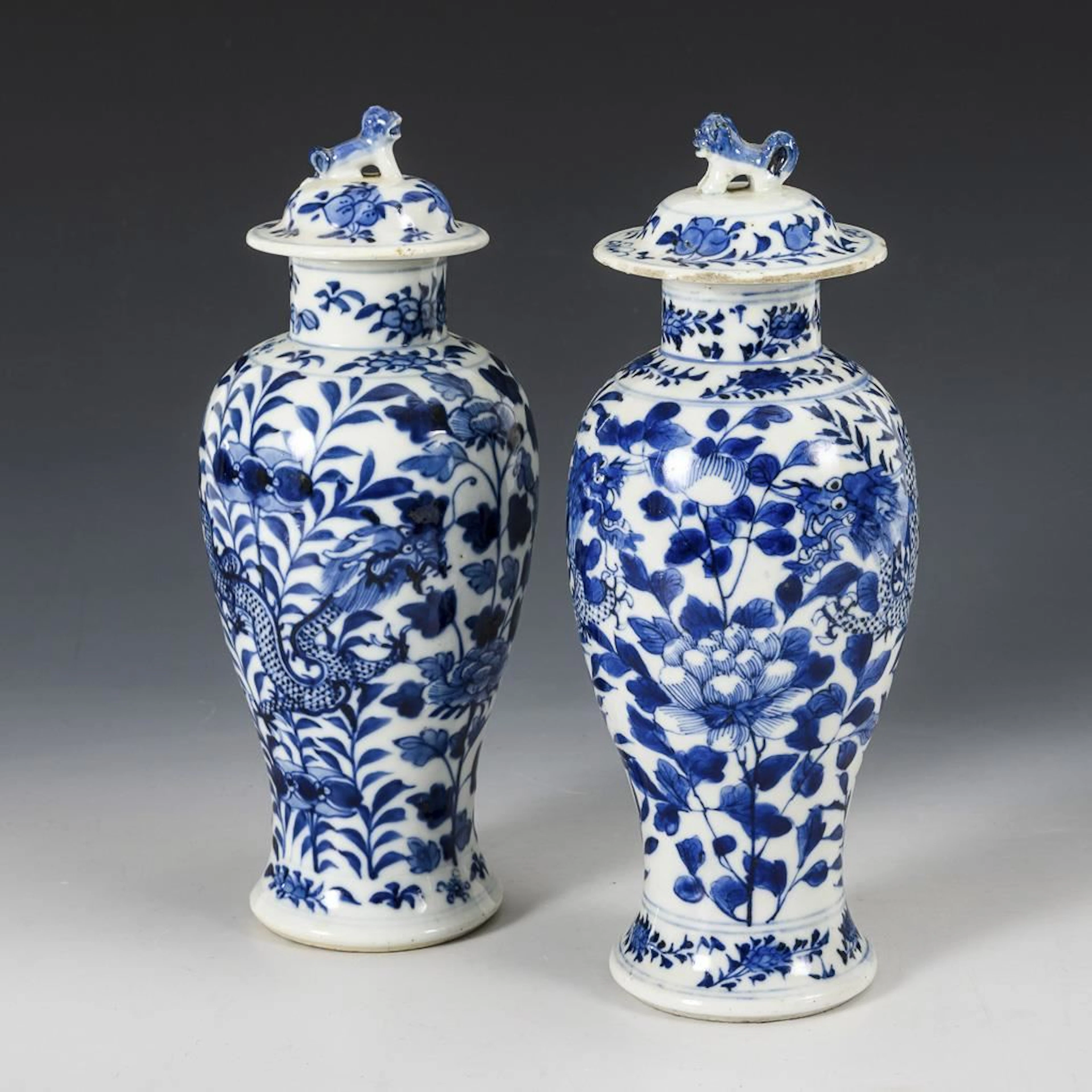 Two similar lidded vases.
