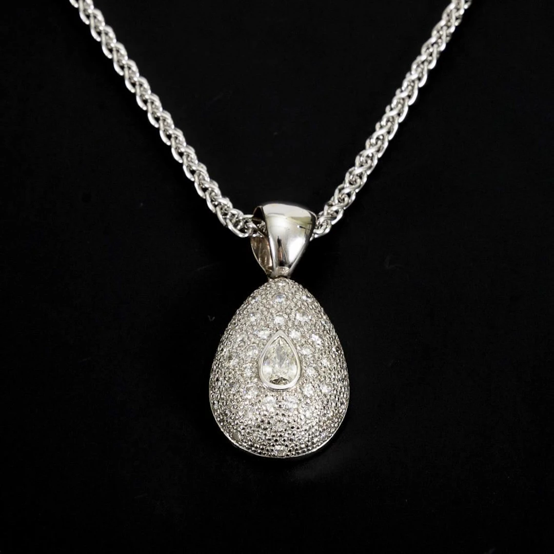 Pendant with a large, teardrop-shaped diamond on a chain.