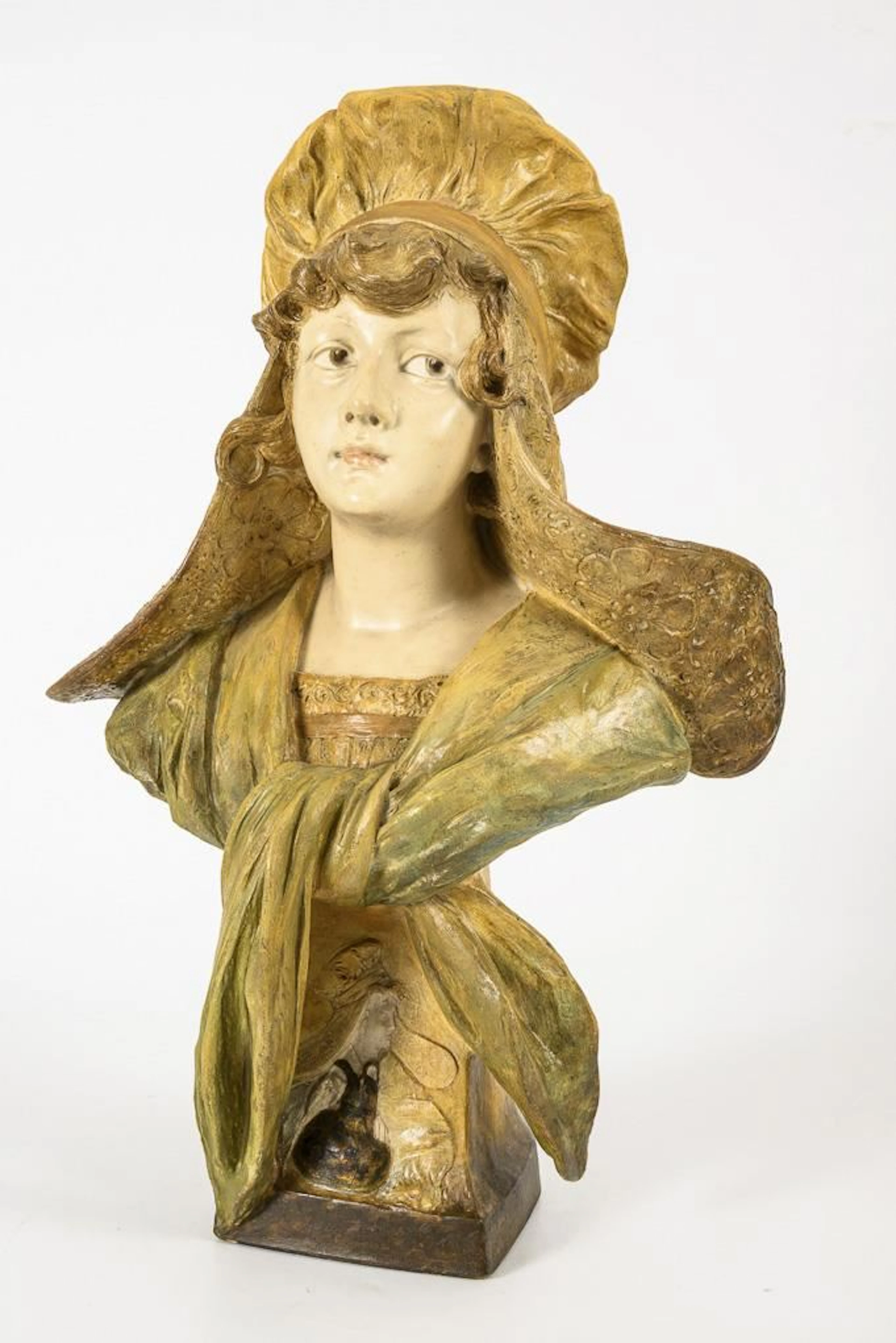 Bust of a lady wearing a bonnet.