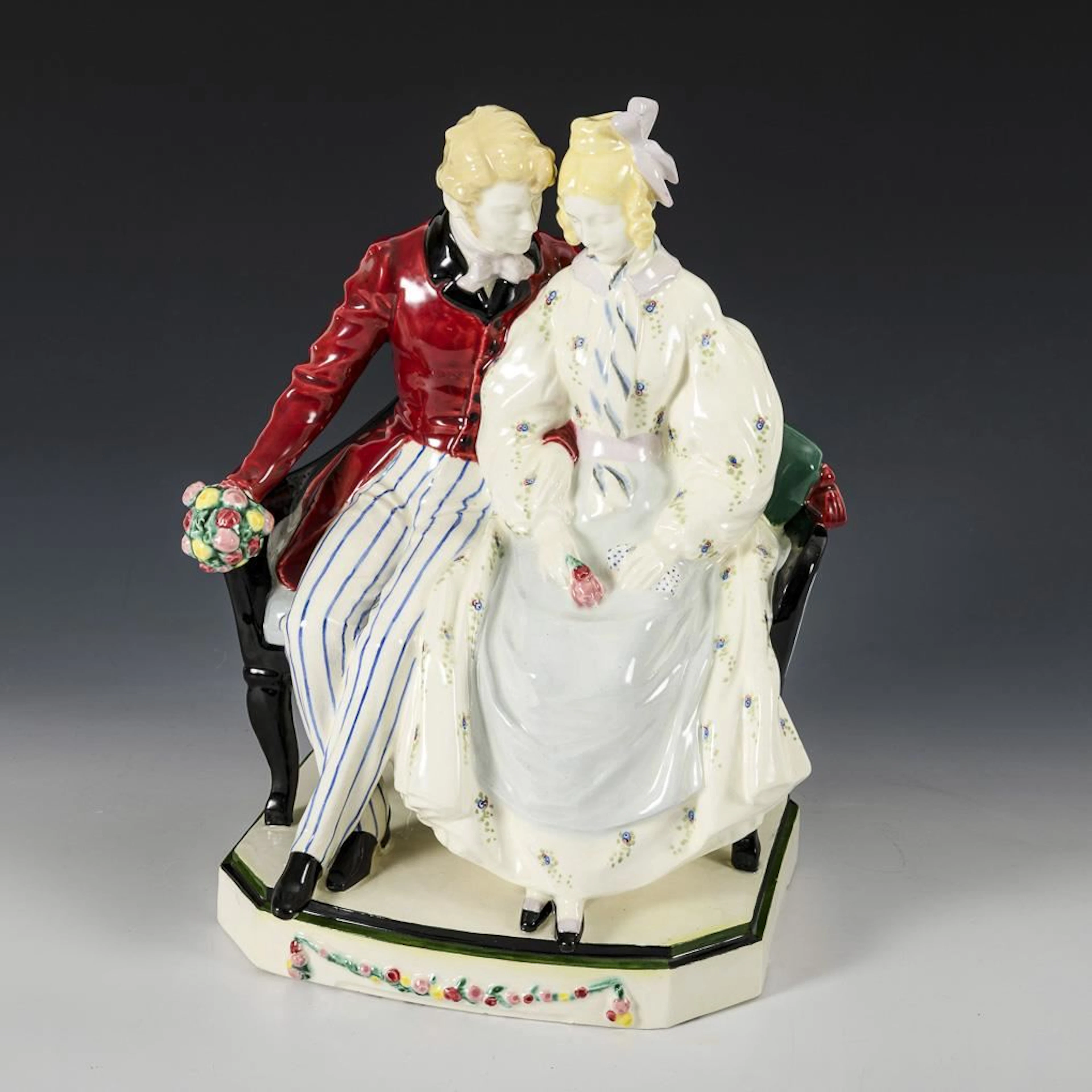 Couple sitting on a sofa. Keramos, Viennese art ceramics.