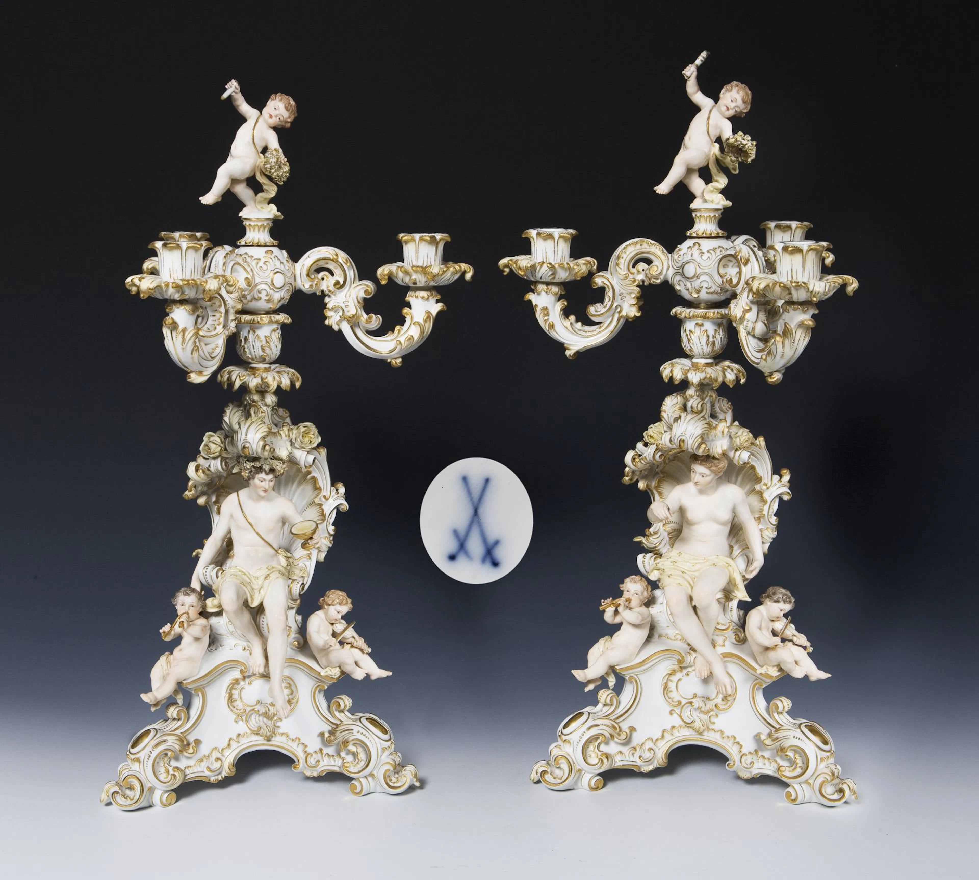 Pair of large candlesticks with Bacchus, nymph and cupids. Meissen.