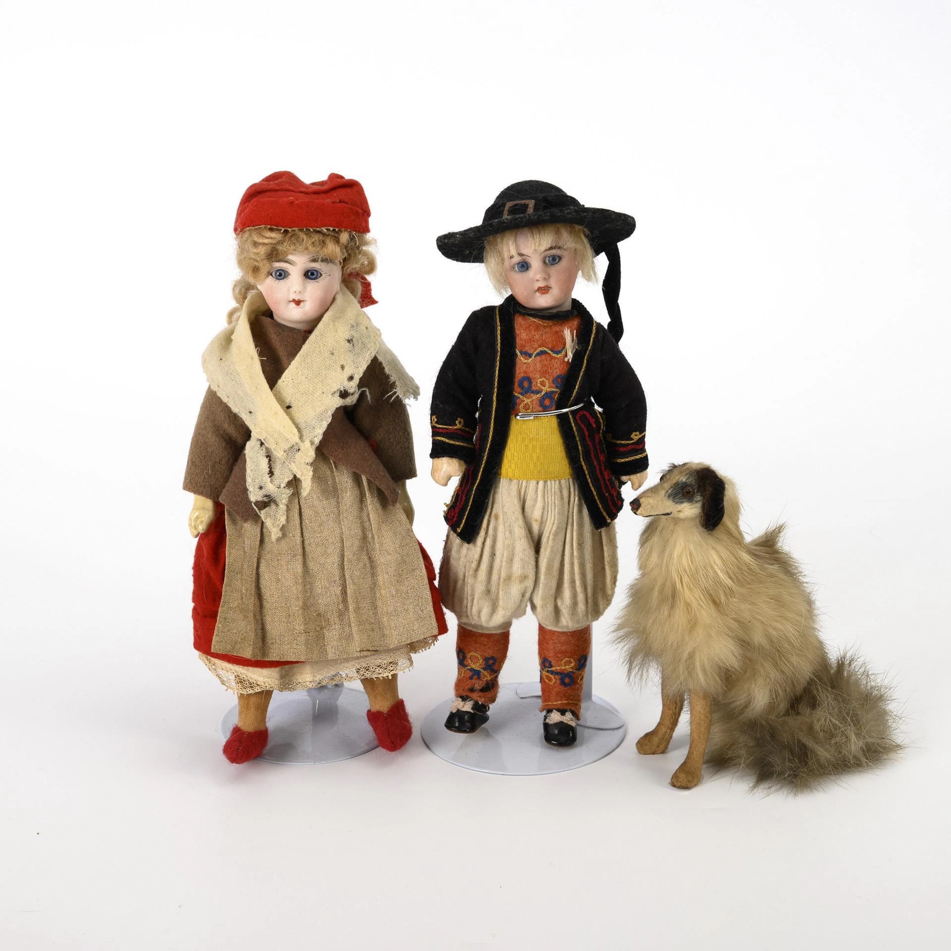 2 traditional costume dolls with greyhound.