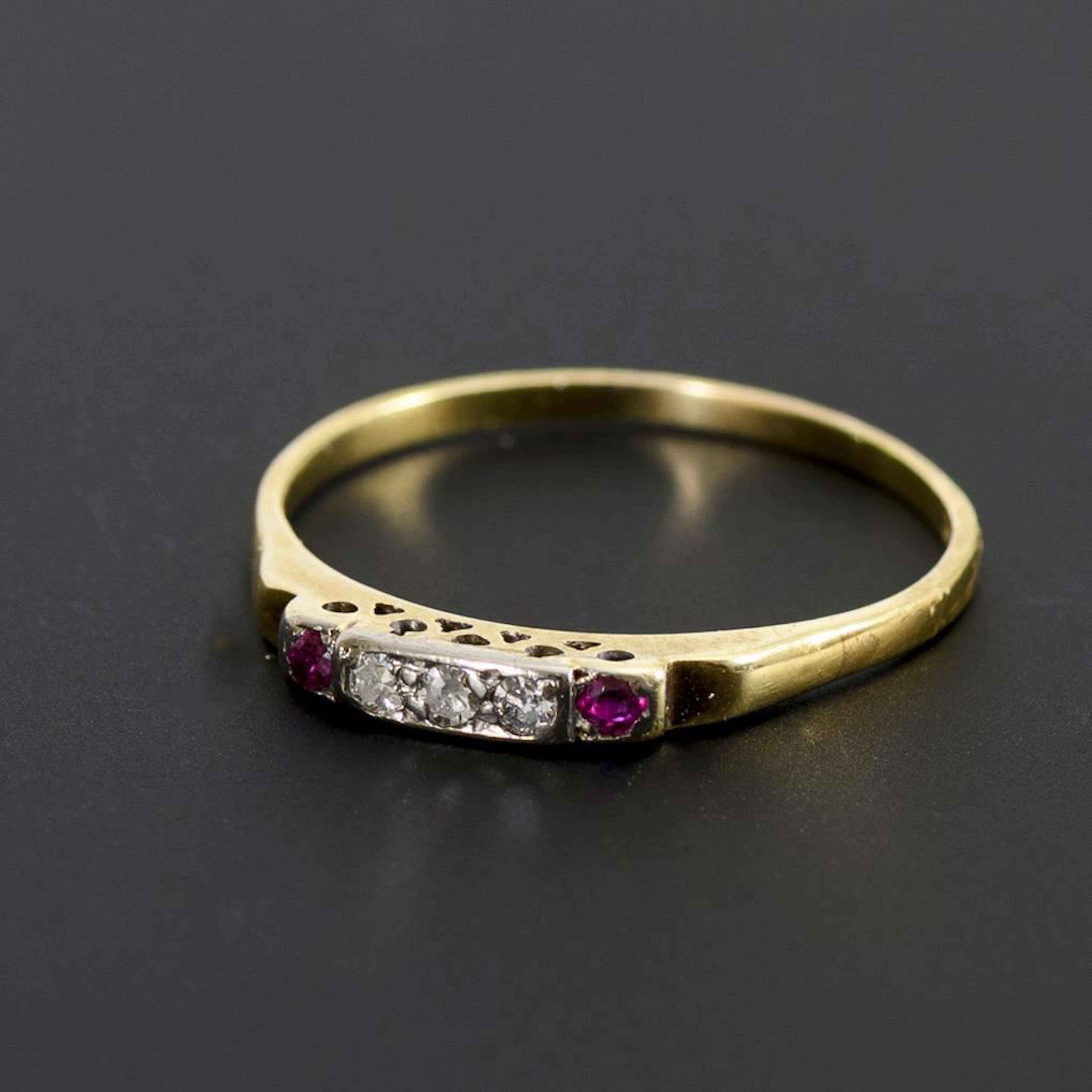 Delicate ring with diamonds and red gemstones.