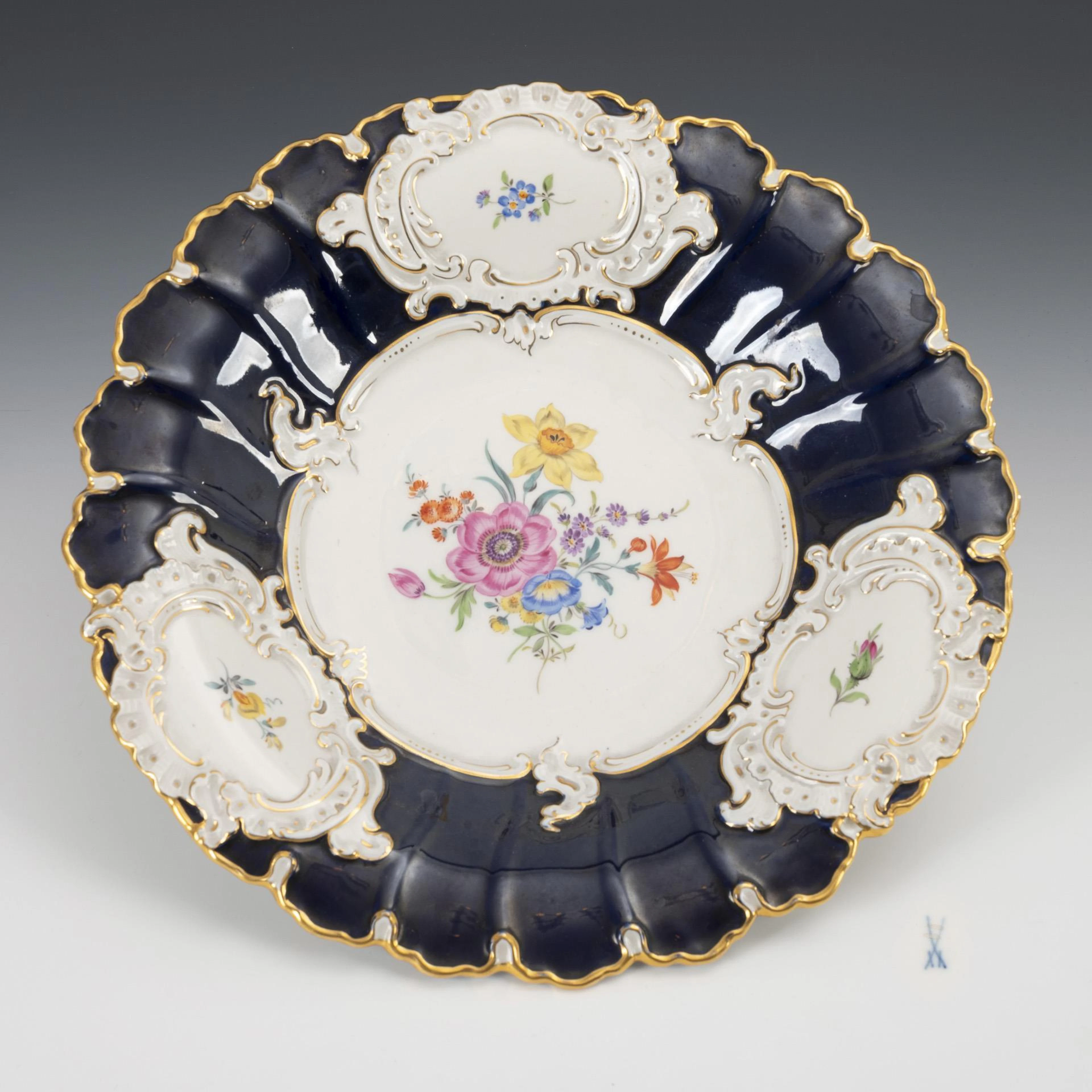 Prunk bowl with cobalt background and flower painting. Meissen.