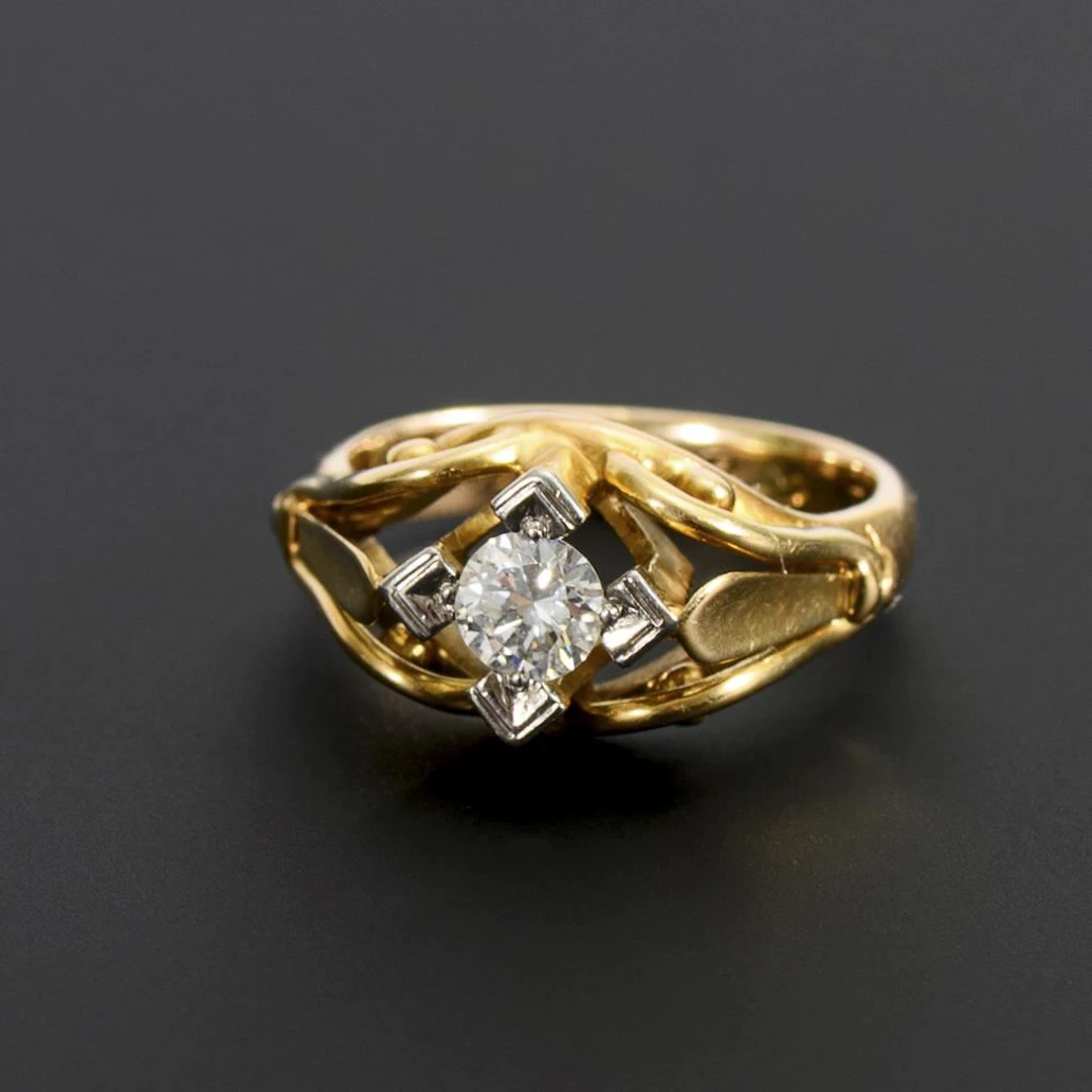 Ring with a solitaire brilliant-cut diamond.