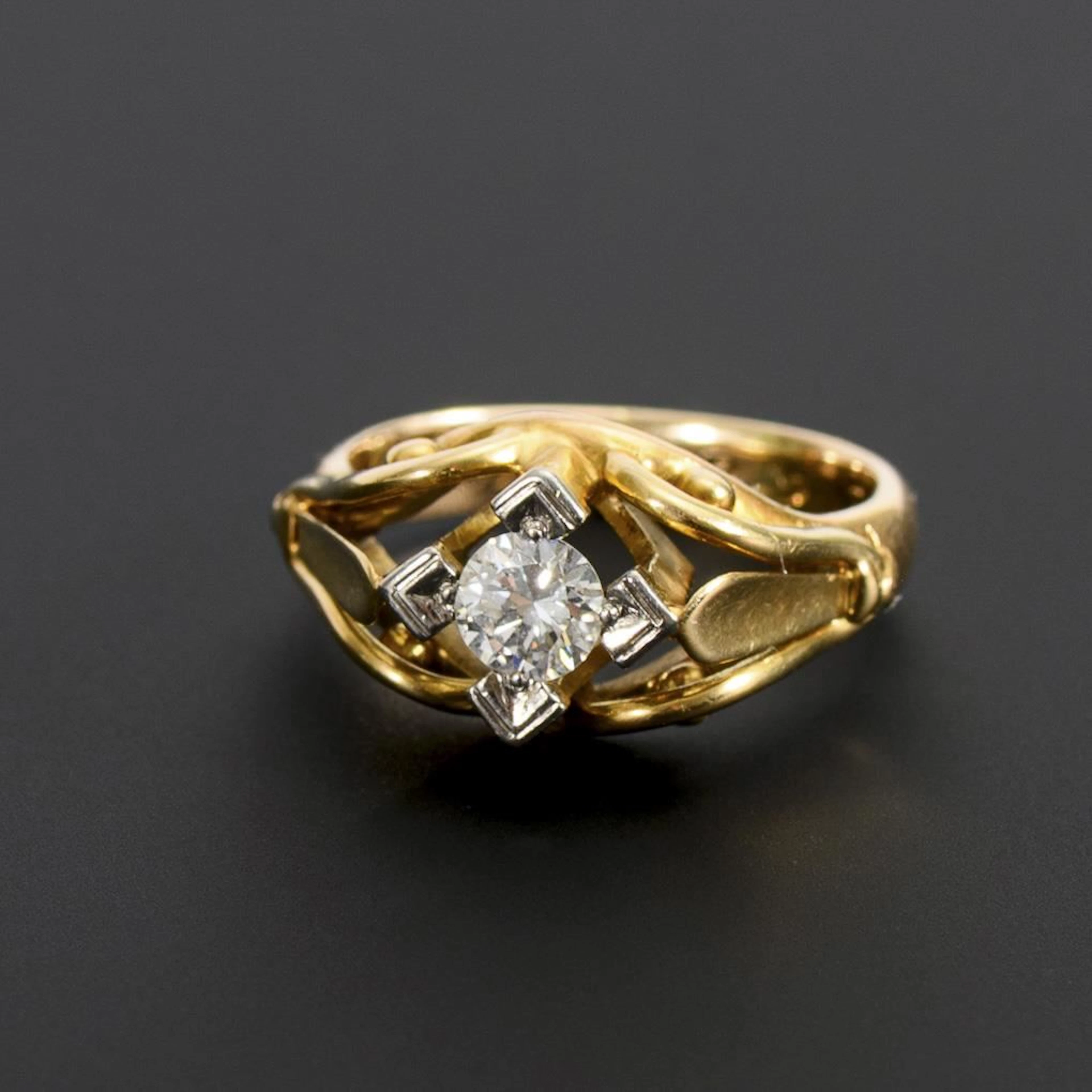 Ring with a solitaire brilliant-cut diamond.