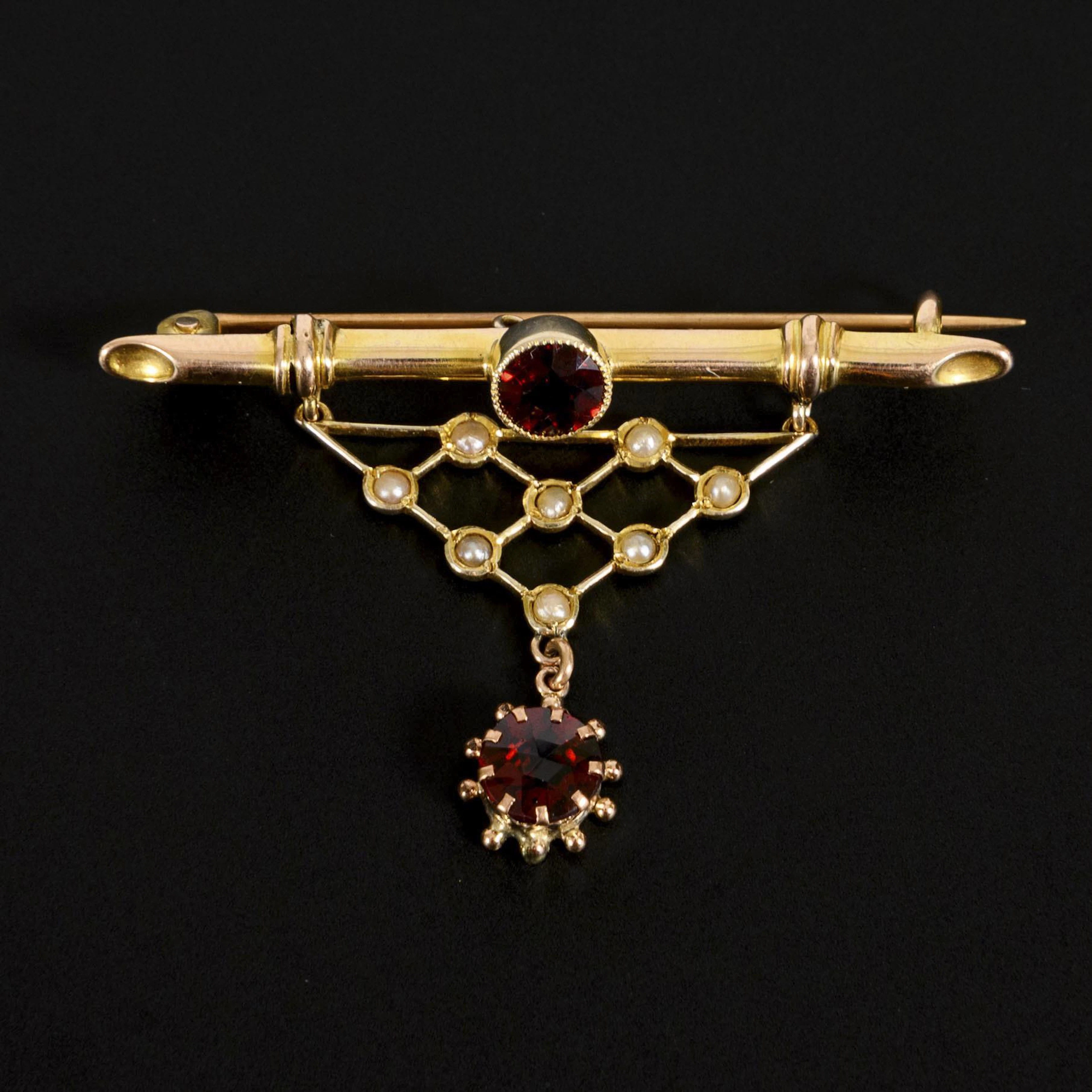 English Art Nouveau brooch with garnet stones and seed pearls.
