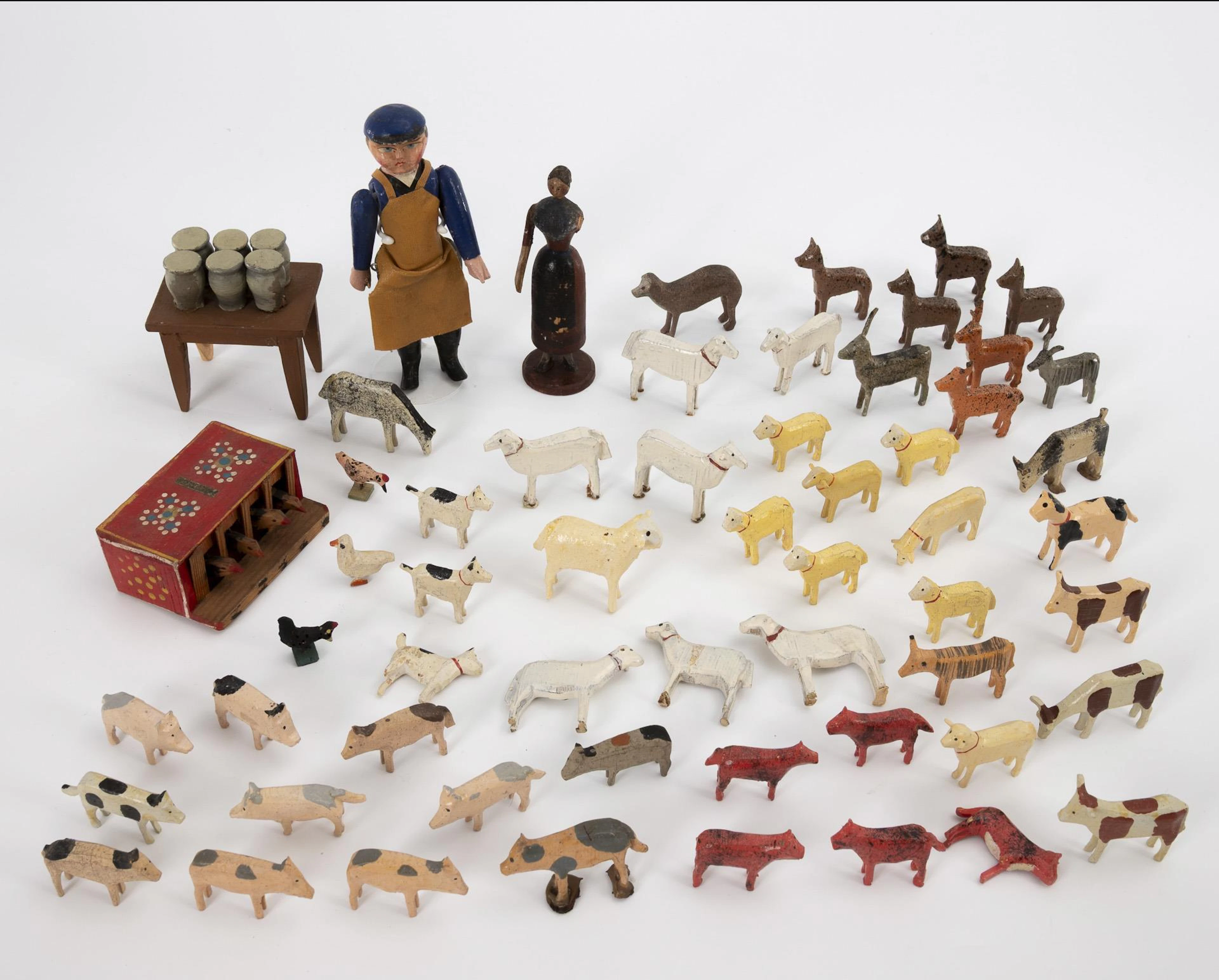 A collection of old tire animals, 2 larger wooden figures and chicken coop.