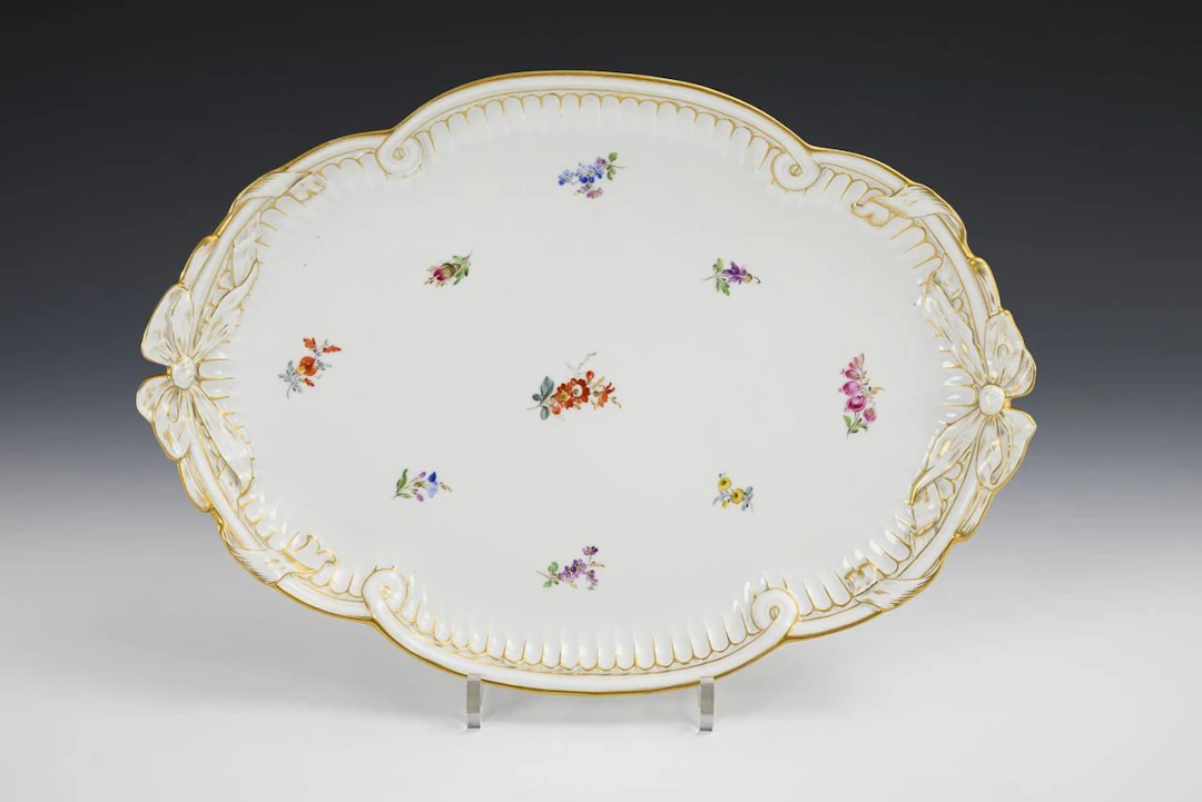 Oval plate with loop handles and scattered flower design. Meissen.