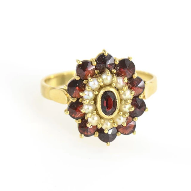 Entourage ring with garnet and seed pearls.