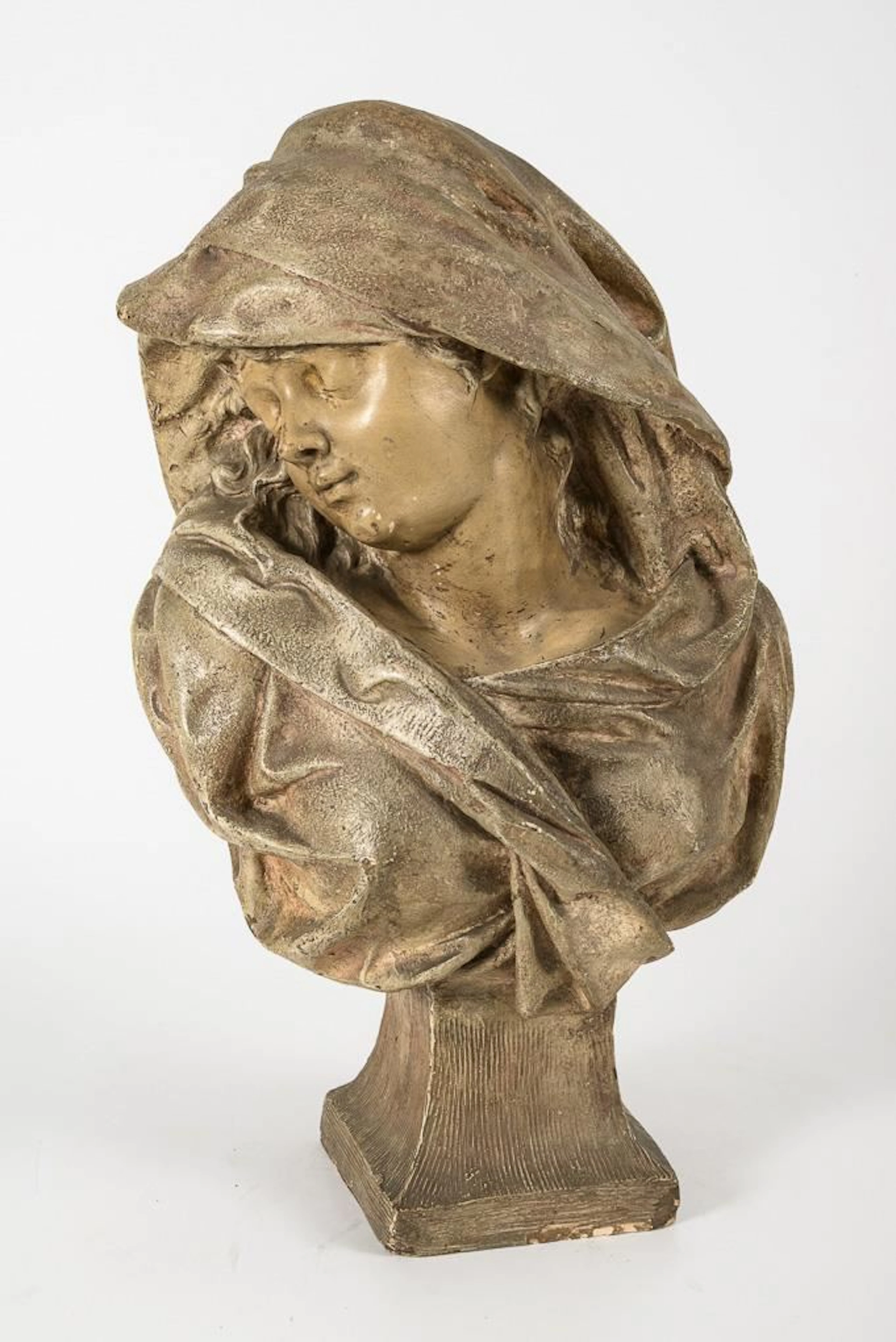 Art Nouveau bust of a young woman with her eyes closed.