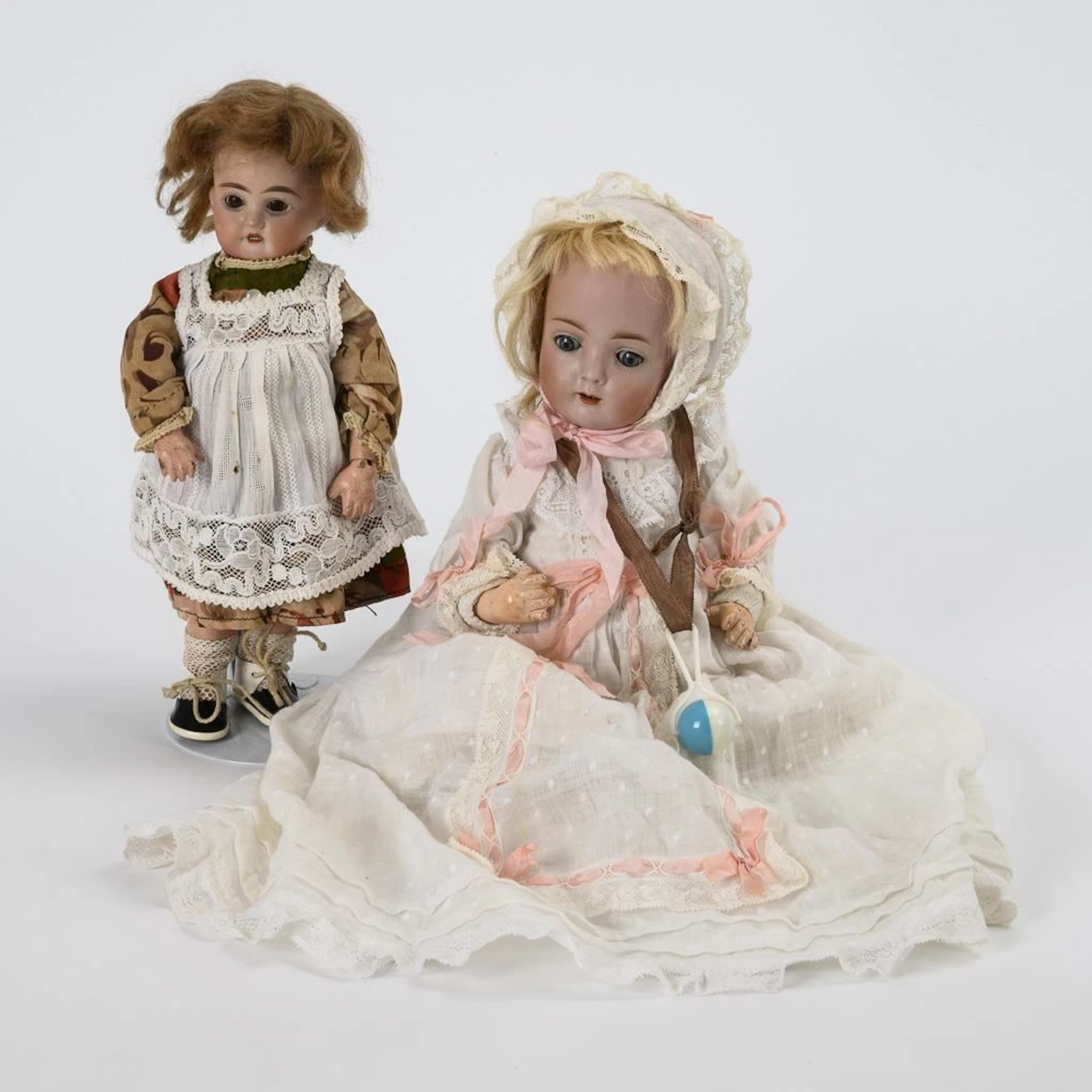 2 small porcelain head dolls.