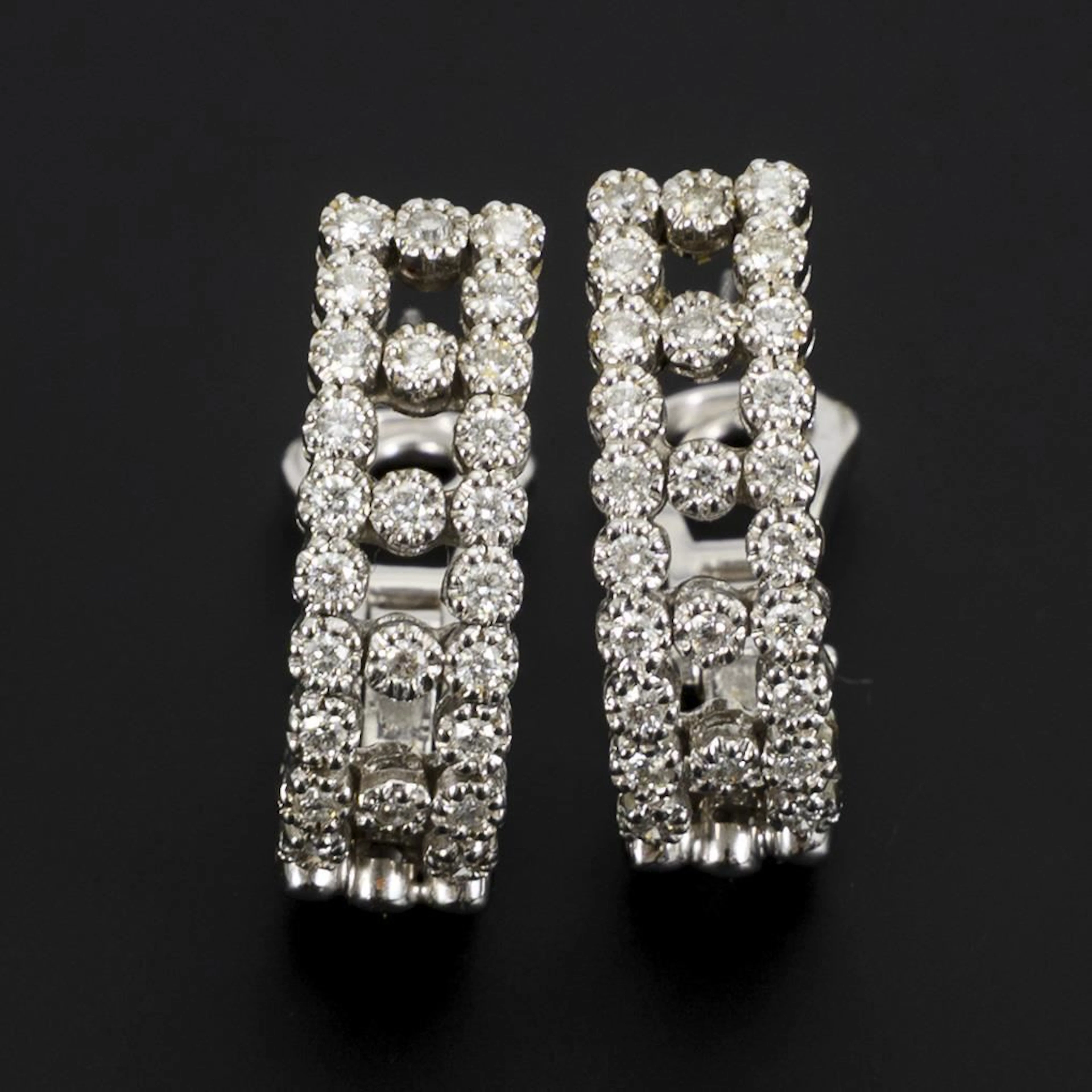 Clip-on earrings in a half-hoop style set with brilliant-cut diamonds.