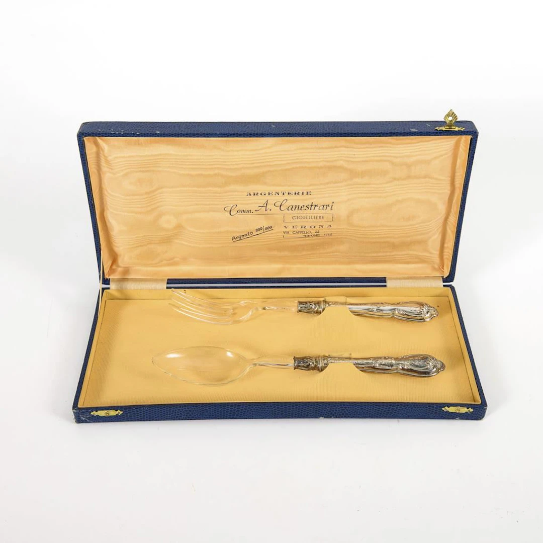 Salad servers with silver handles, in a blue case.