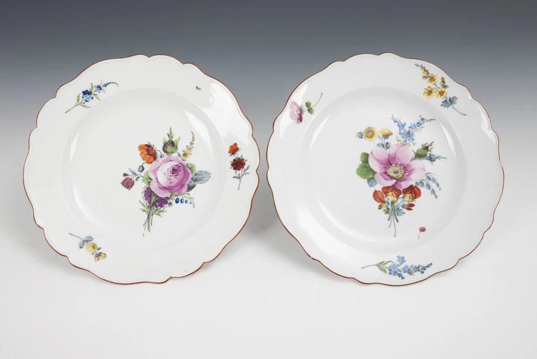 2 dinner plates with floral designs. Meissen.