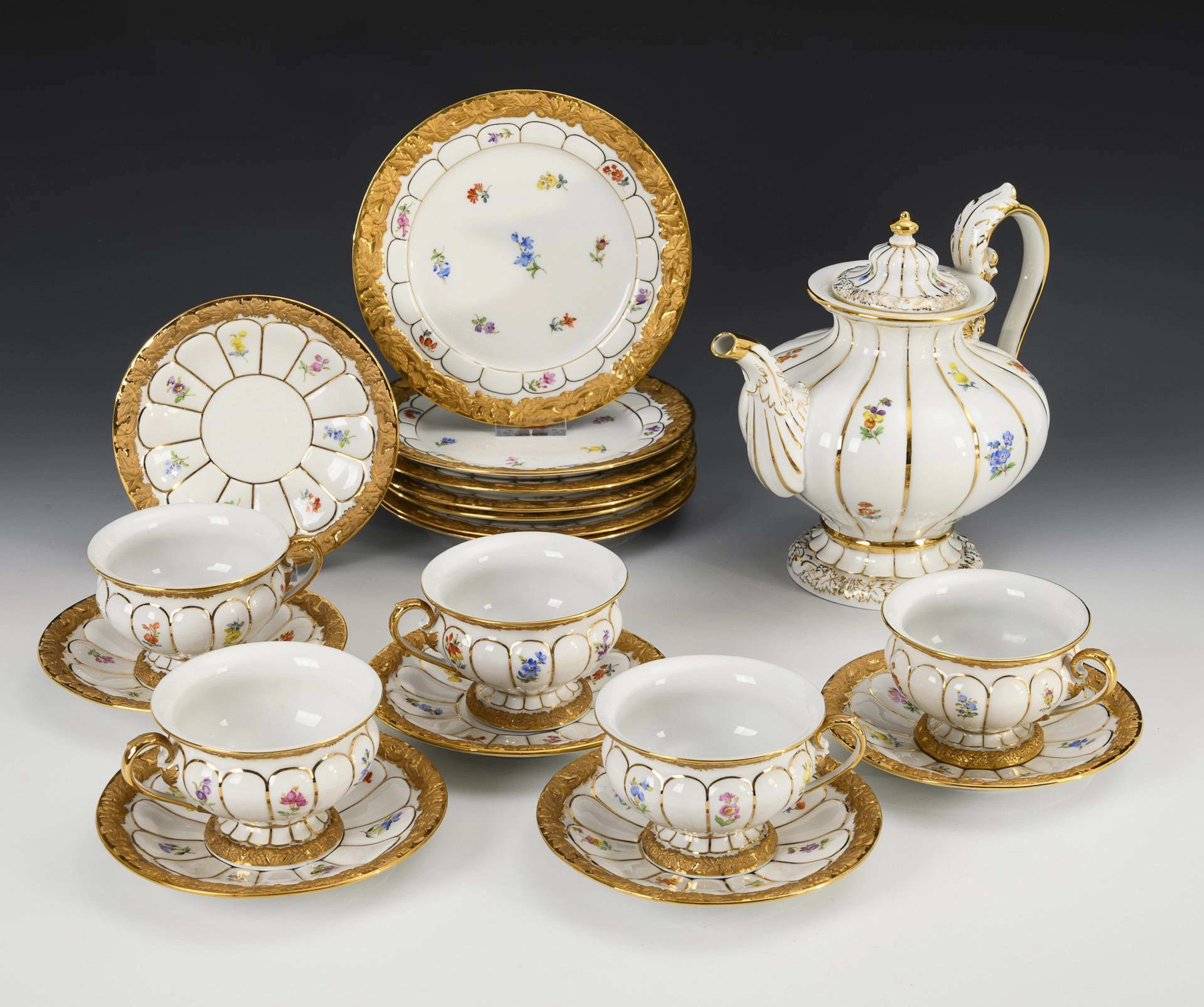 19 pieces of a tea service "X-shape" with scattered flower painting. Meissen.