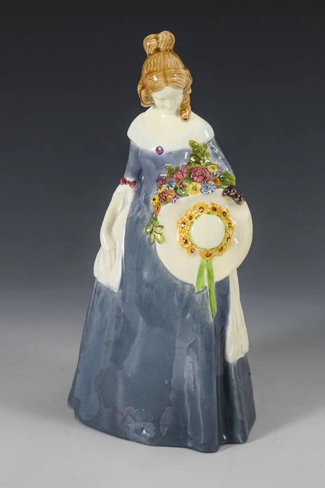 Woman in a blue dress and hat. Vienna Art Ceramics Workshop Busch & Ludescher.